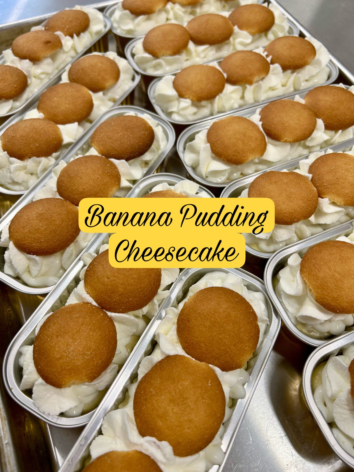 Multiple banana pudding cheesecakes topped with cookies in clear containers, arranged on a surface.