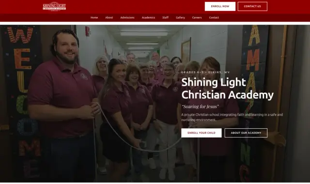 Group of students in maroon uniforms standing in hallway with welcoming signs, smiling at camera.