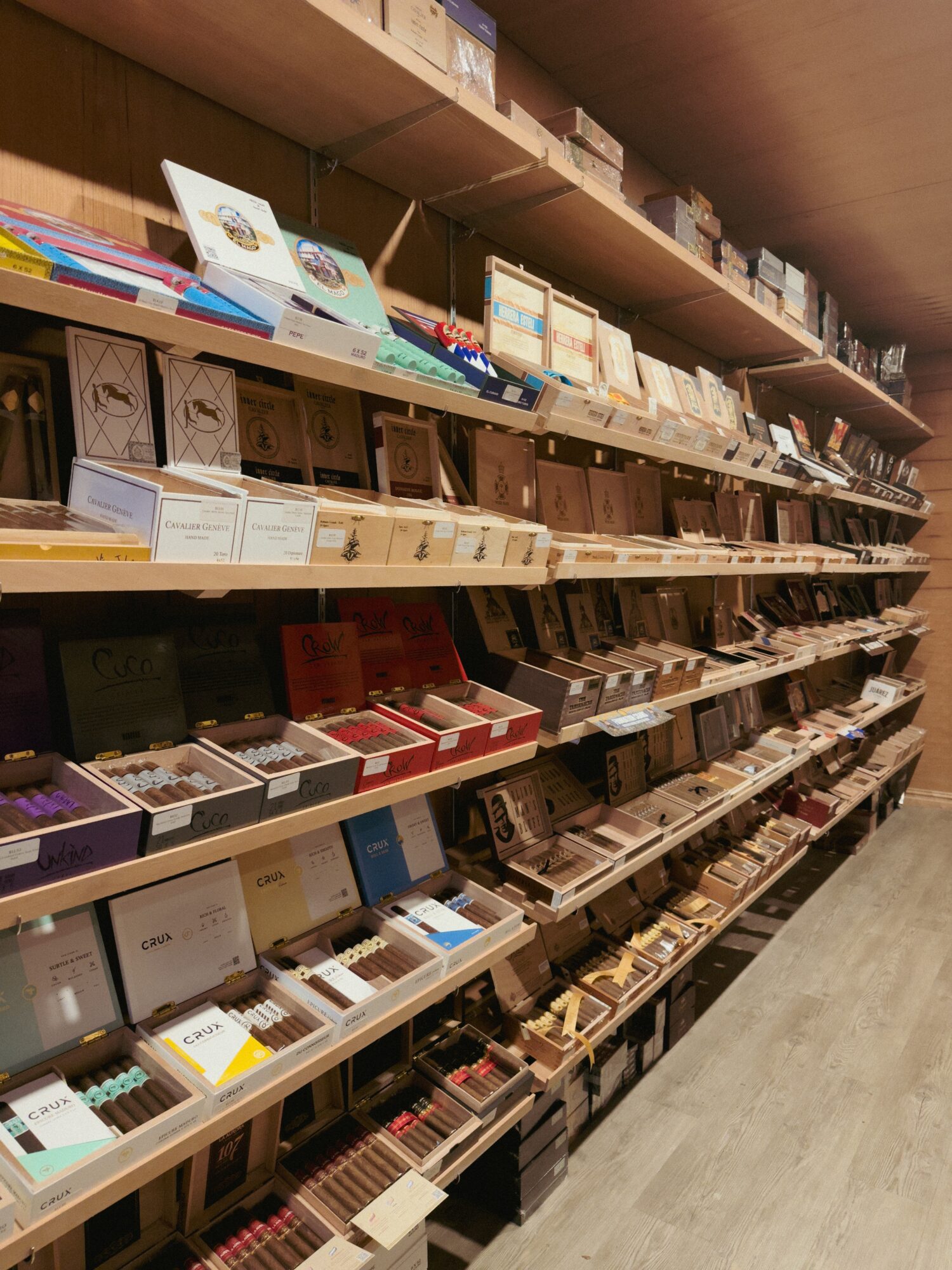 Bookshelves filled with books and magazines in a store or library, arranged on multiple shelves, with a wooden ceiling above.