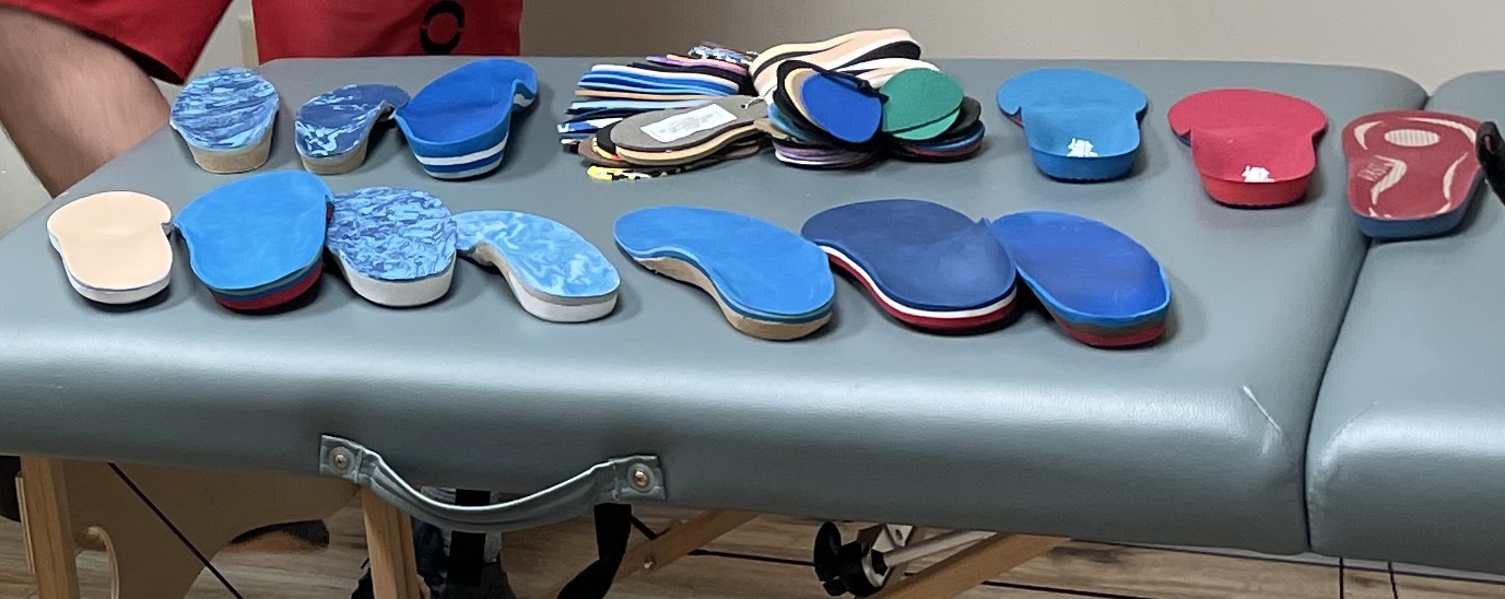 Various colorful fabric pieces and cutouts arranged on a gray table surface.