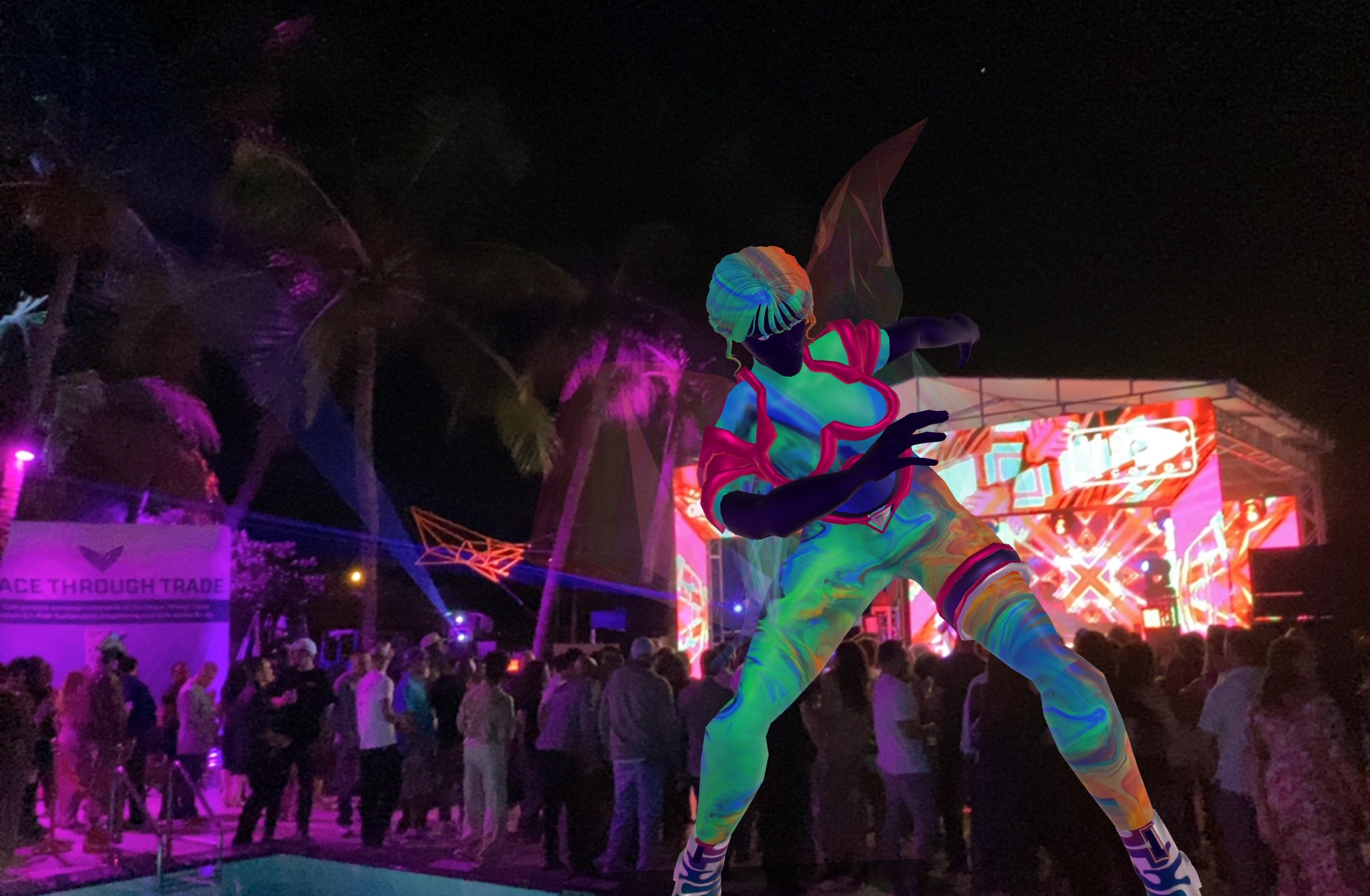 Large colorful statue of a character with a sword, surrounded by a crowd at night with bright lights and palm trees.