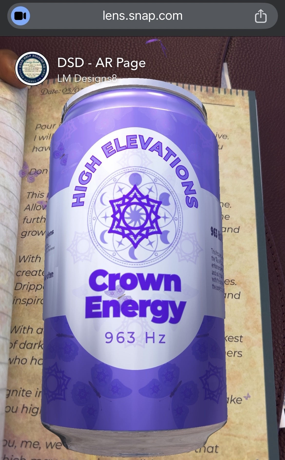 Purple can with a web design and text, placed on an open book, with a background of a maroon surface.