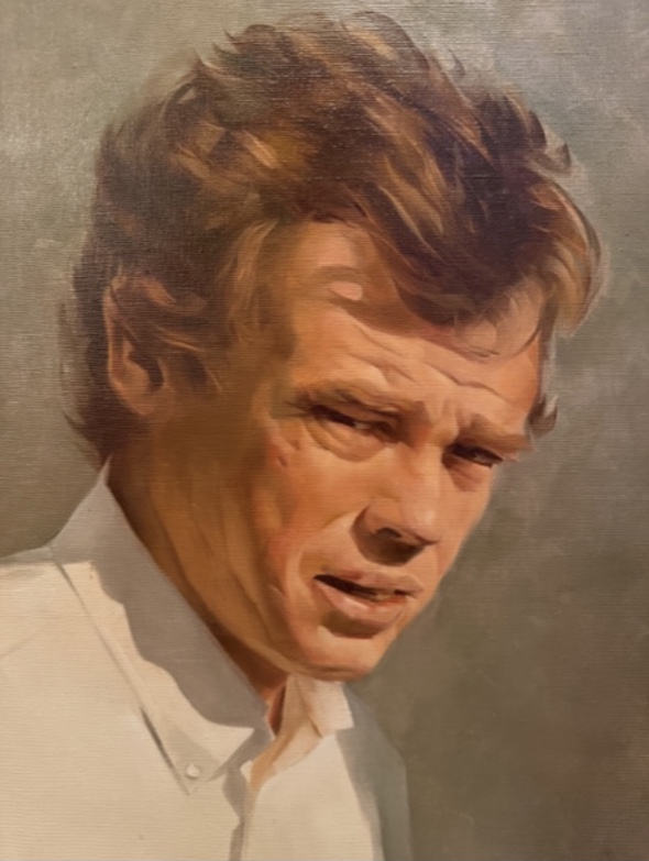 Portrait of a man with wavy hair wearing a white shirt, looking to the side with a serious expression.