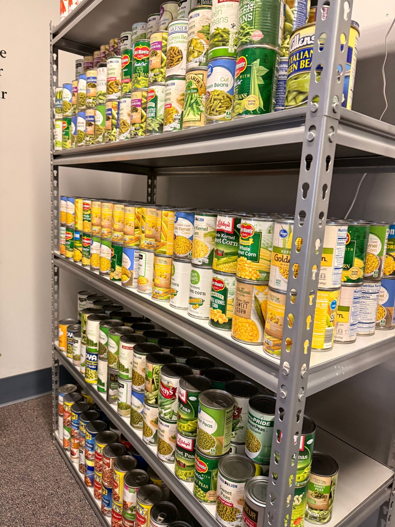 Shelves stocked with various canned and bottled beverages in a store, viewed from above.