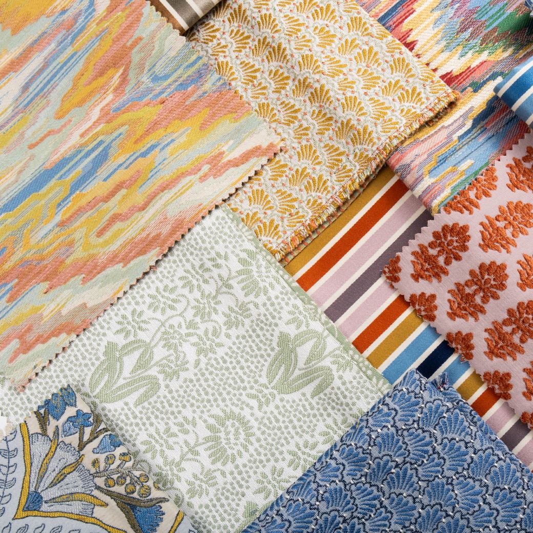 Collection of colorful fabric swatches with various patterns including floral, geometric, and abstract designs.