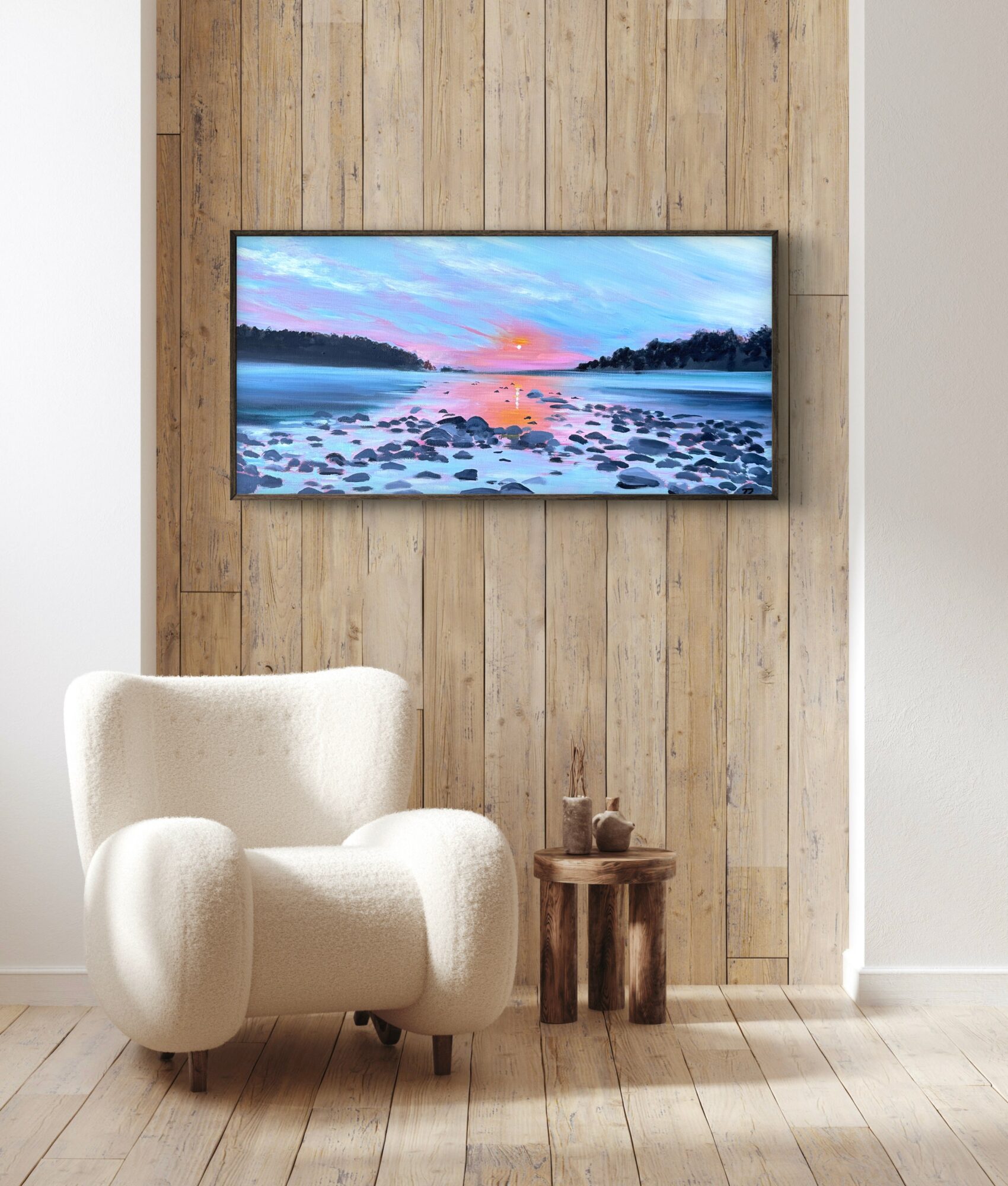 Living room with a white armchair, small wooden table, and a wall-mounted TV displaying a landscape scene.