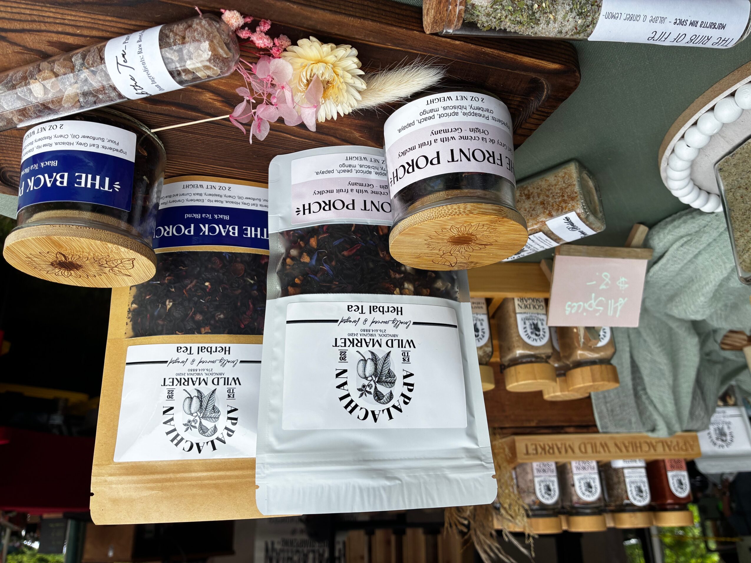 Various skincare products, a small bouquet of flowers, and a box on a table.
