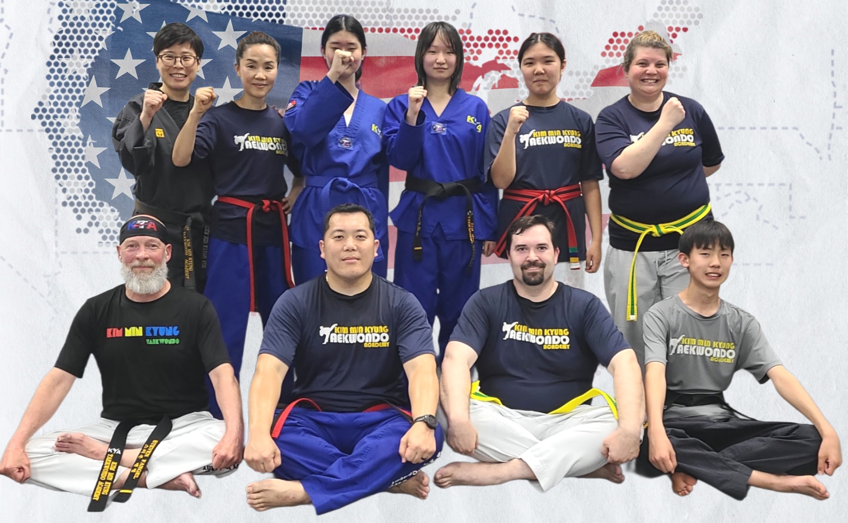 Group of ten martial artists in uniforms and casual clothing, posing with fists raised, on a decorated background.