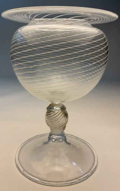 Glass vessel with a wide, rounded body, a narrow stem, and a flat circular base, featuring intricate swirling patterns.