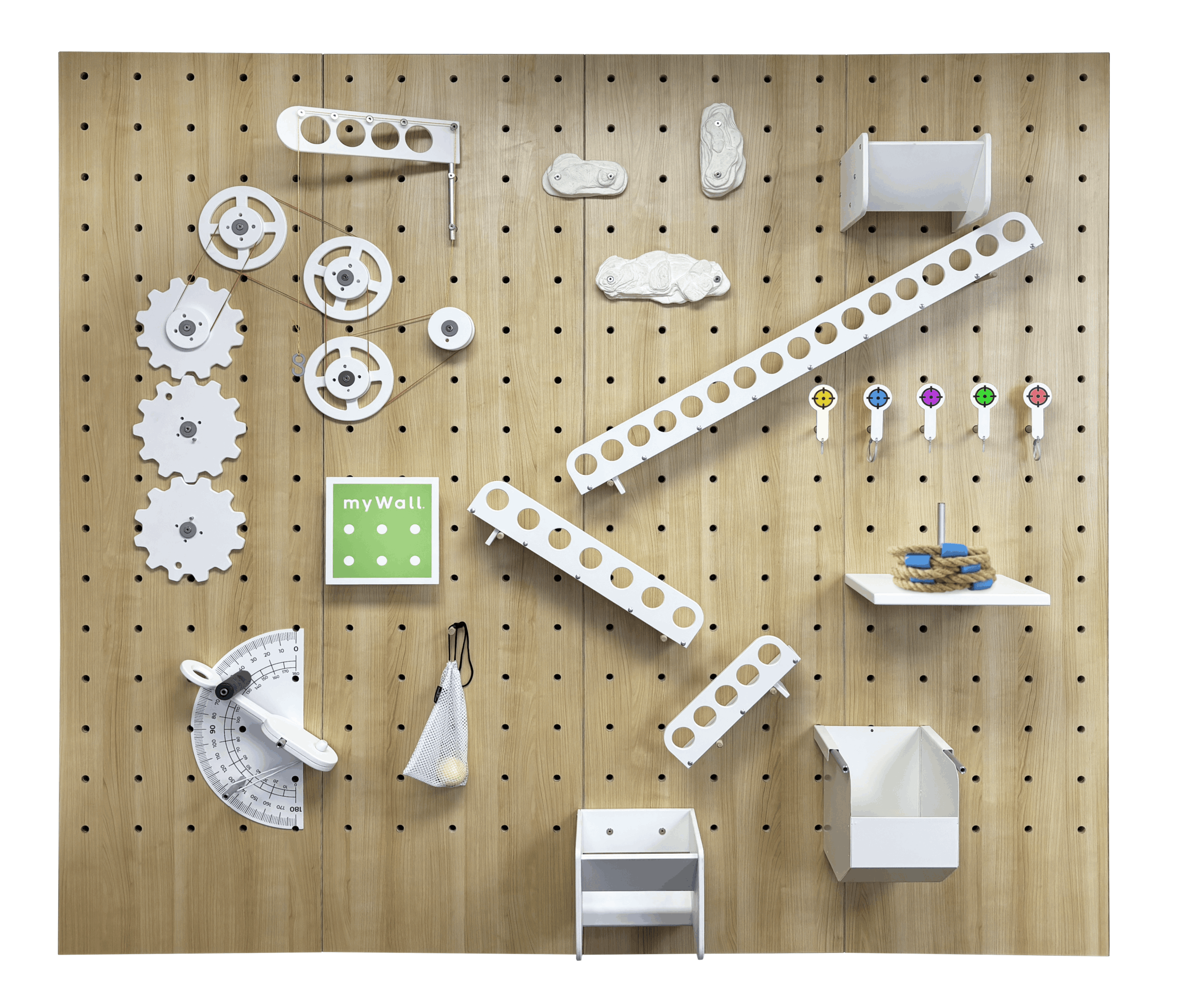 Wooden pegboard with white mechanical parts, a green sign, and small colorful objects, arranged in a pattern.