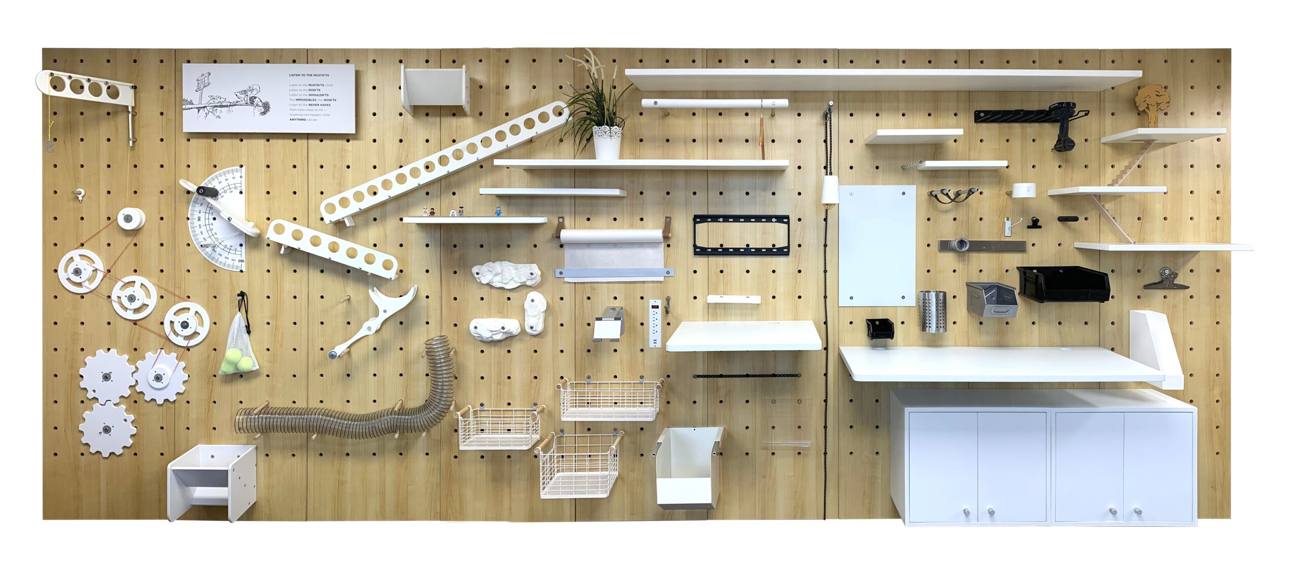 Pegboard wall with various white and black shelves, gears, and tools arranged neatly, with a white cabinet below.