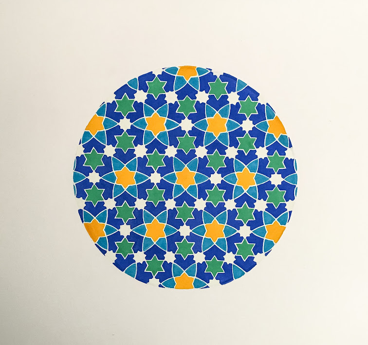 Colorful circular mosaic pattern with blue, green, and orange geometric shapes on a white background.