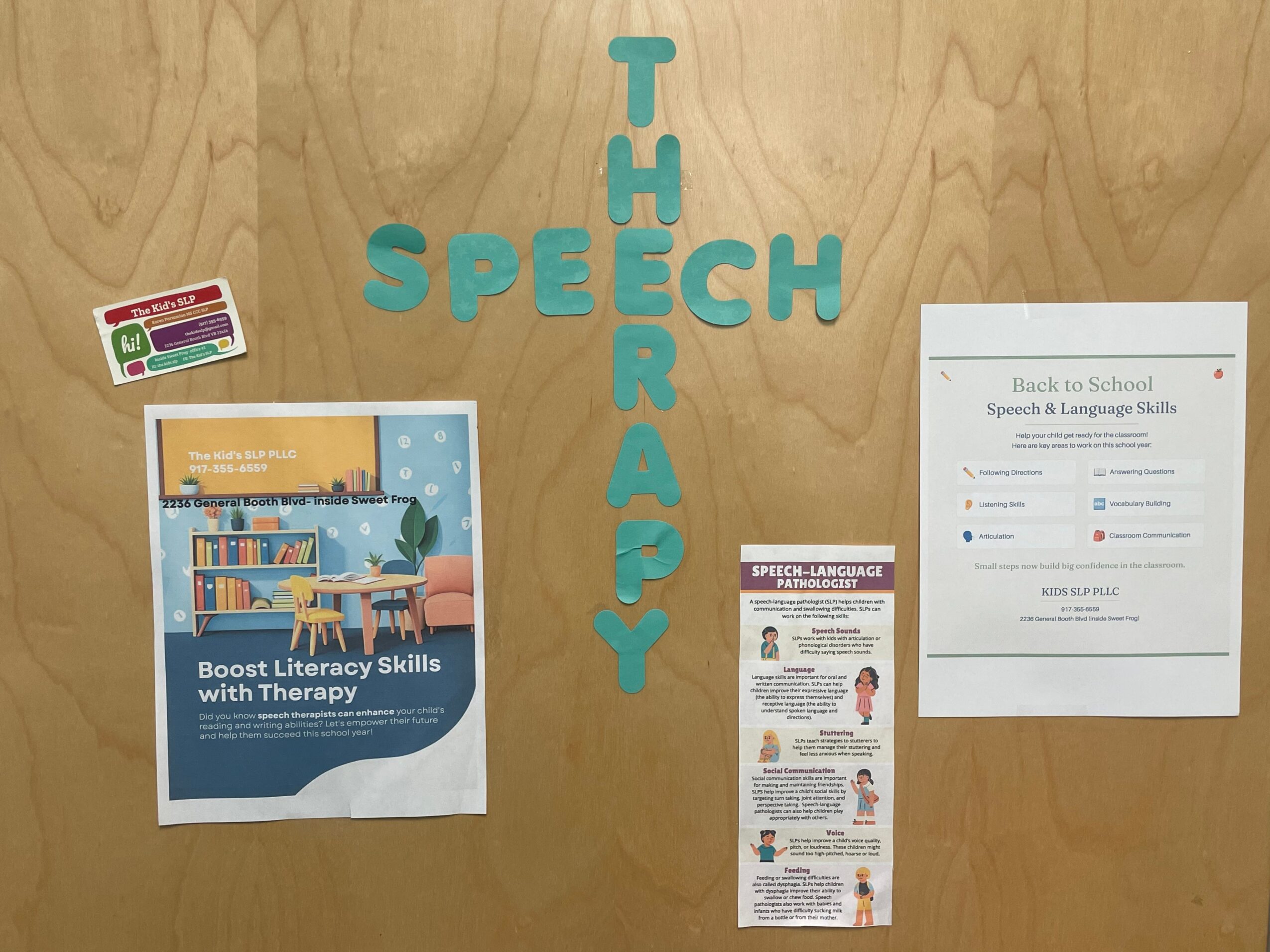 Wooden door with blue letters spelling 'TH' and 'SPEECH' vertically, two papers attached, one with literacy tips and another with back-to-school info.
