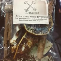 A clear plastic bag contains a turtle with a sign that reads 'Attraction: attract love, money, opportunity' and a small stick.