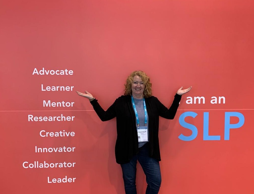 Woman standing with arms outstretched in front of a pink background with words related to speech-language pathology.