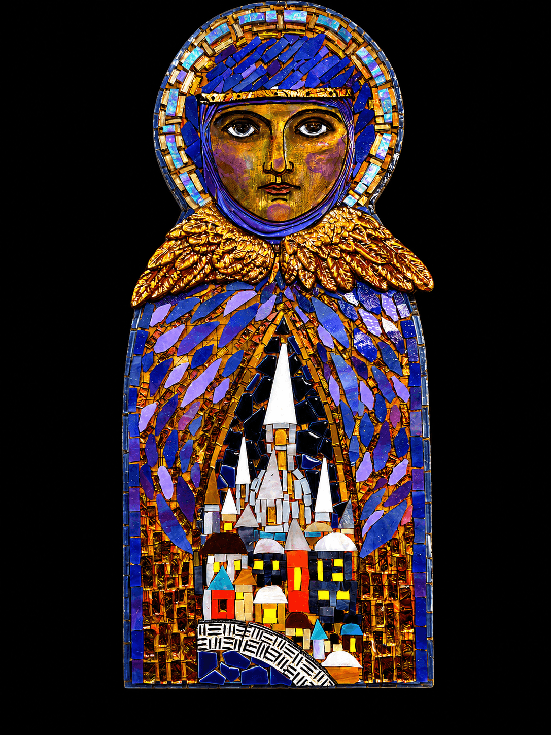A stained glass depiction of a person with a halo, wearing a blue and gold cloak, holding a castle and cityscape.