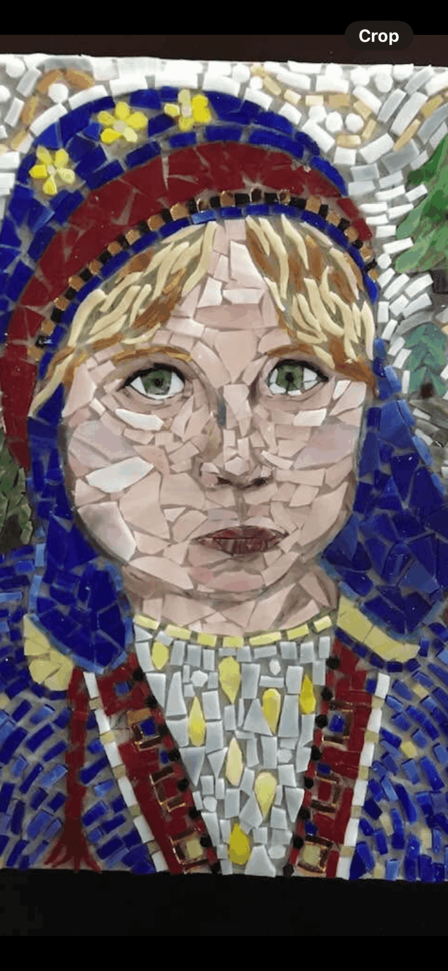 Mosaic portrait of a person wearing a colorful hat and glasses, with detailed facial features and decorative clothing.