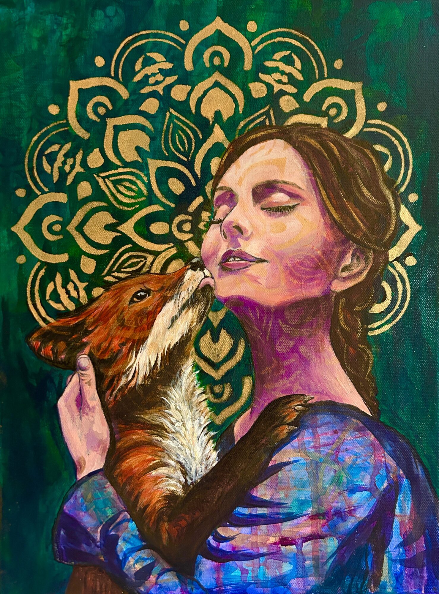 A woman with closed eyes and a fox near her face, against a green background with a gold mandala pattern.