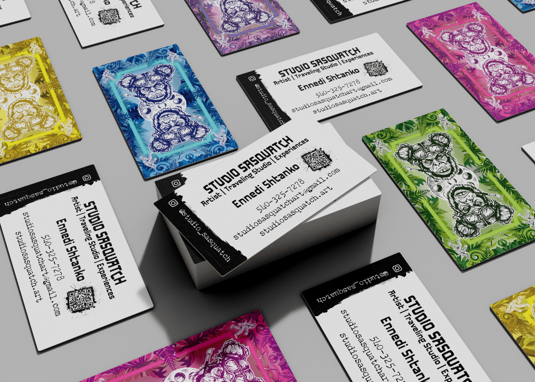 Business cards with colorful abstract designs and text for Studio Security, arranged on a gray surface.