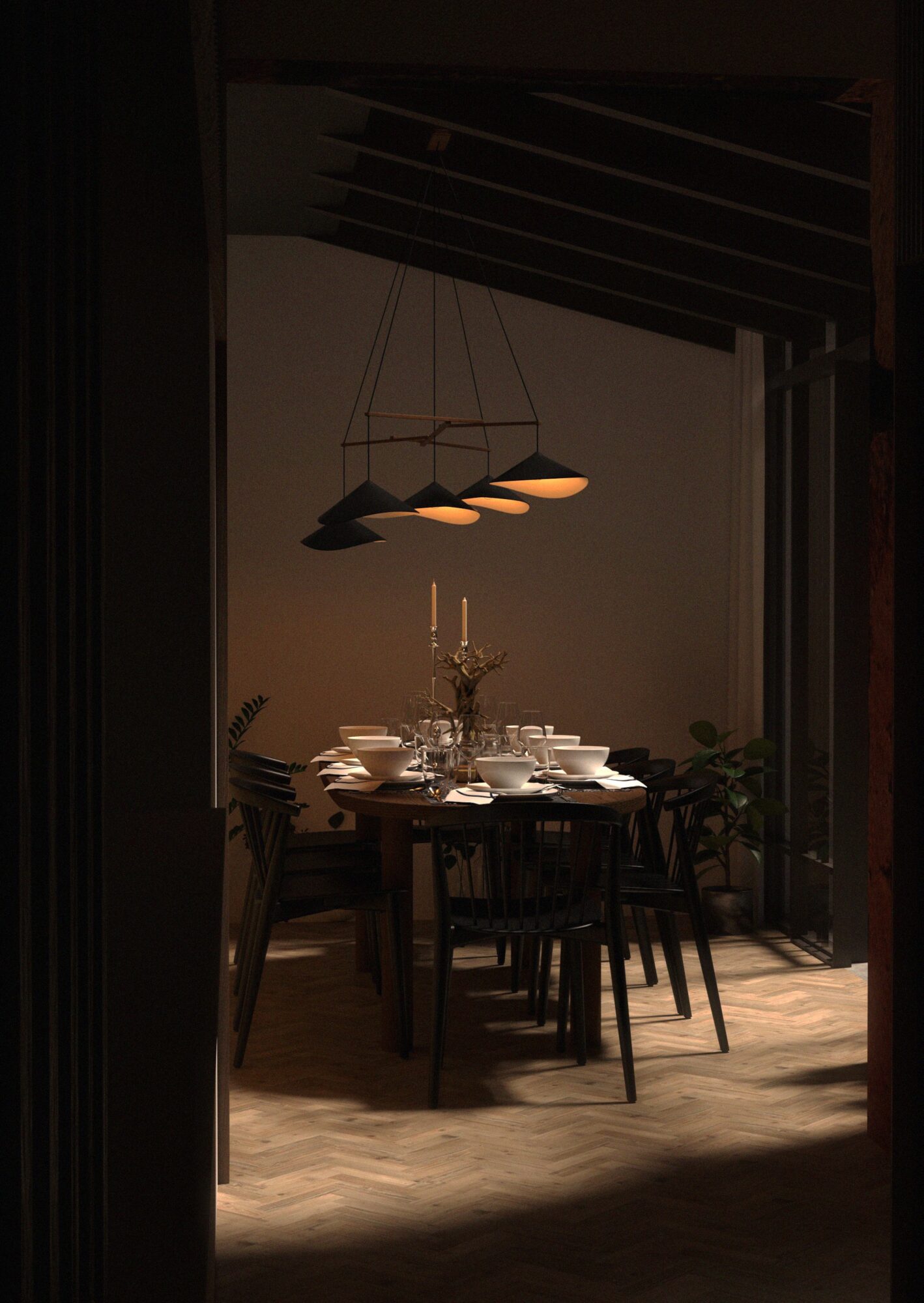 Dining room with a round table set with plates, glasses, and a candelabrum, illuminated by a modern chandelier, with wooden flooring and chairs.
