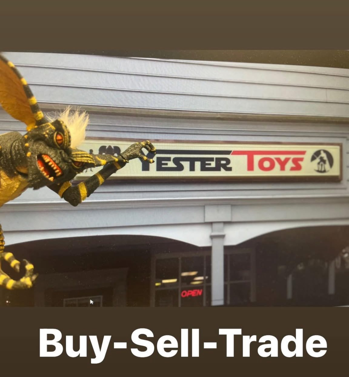 A large dragon figure points at a sign for a toy store named 'Lester Toys' outside a building. The store has an 'Open' sign.