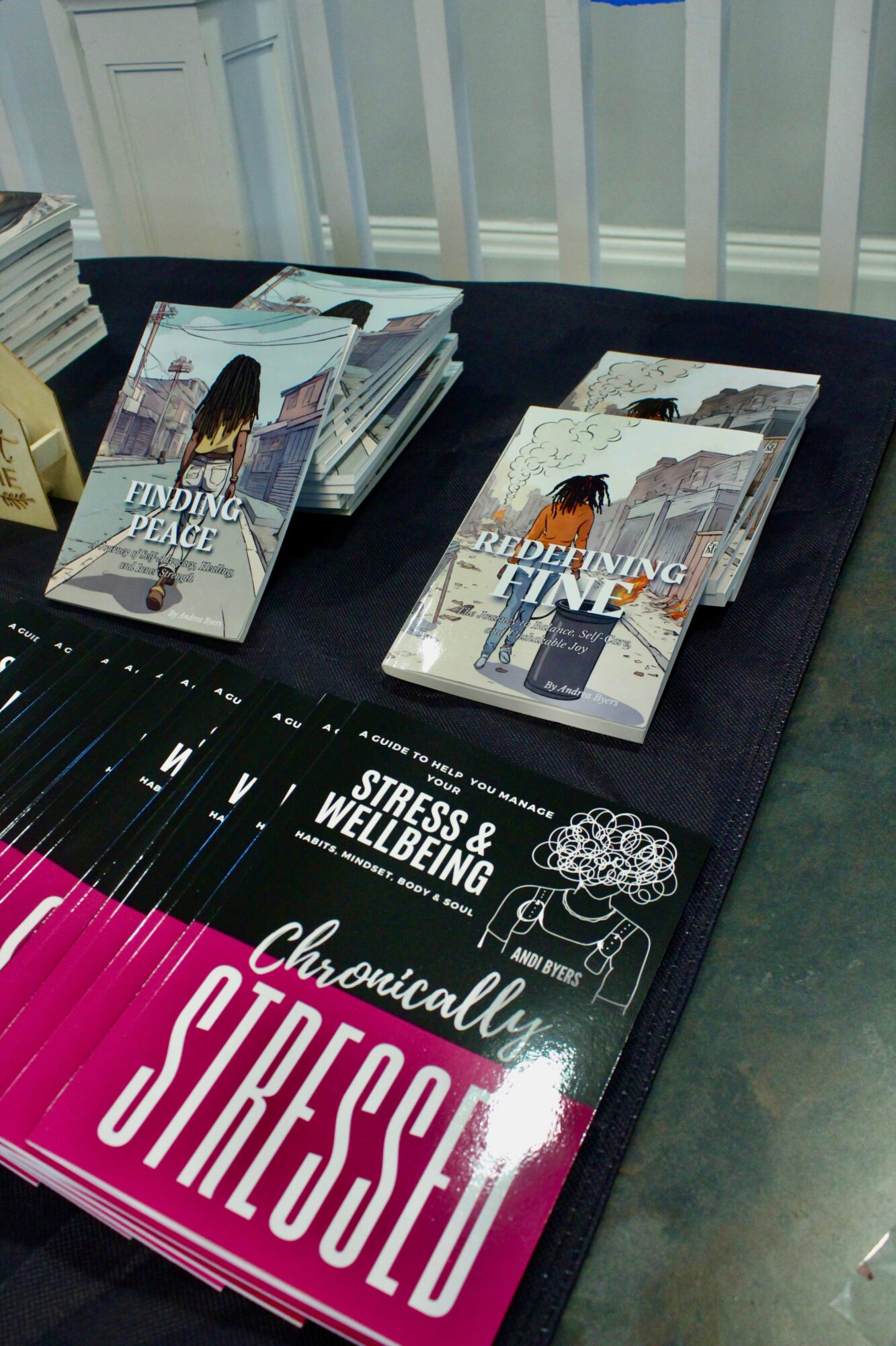 Brochures and booklets on a table, including titles about finding peace and understanding, with a stress and wellbeing mat nearby.