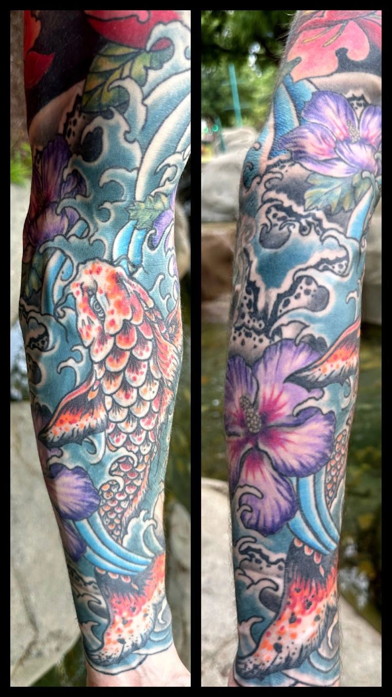 Colorful tattoo sleeve with a koi fish, waves, and flowers on a person's arm.