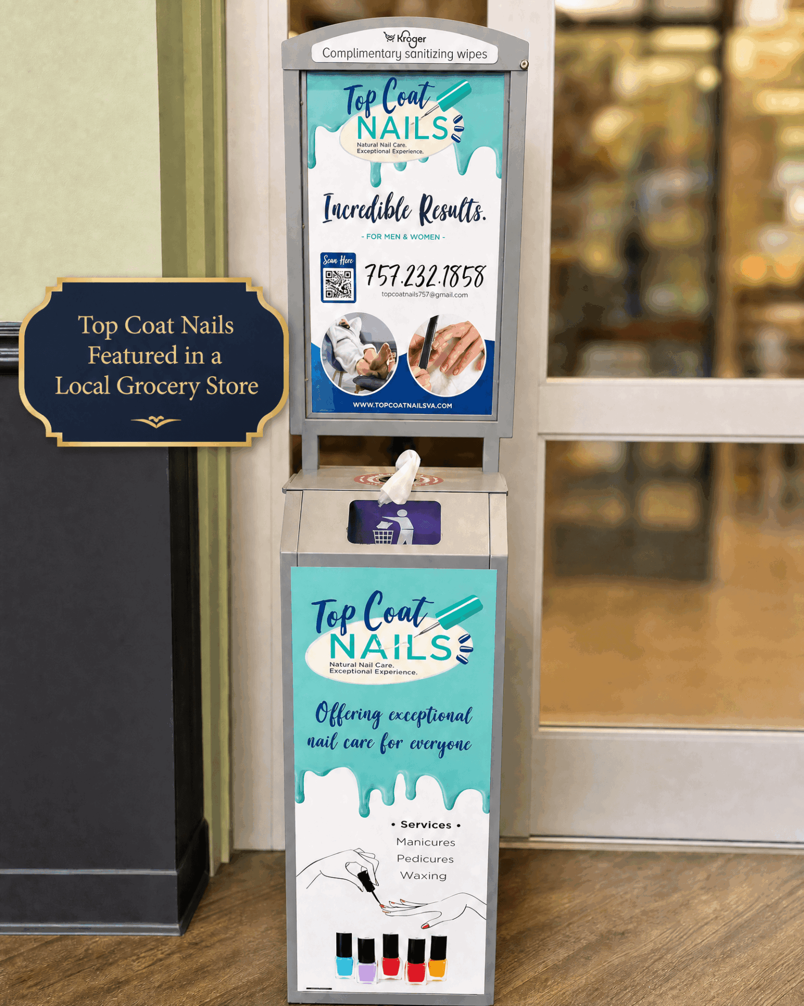 A nail salon advertisement stand with a sign about top coat nails, featuring contact info and colorful nail polish images.