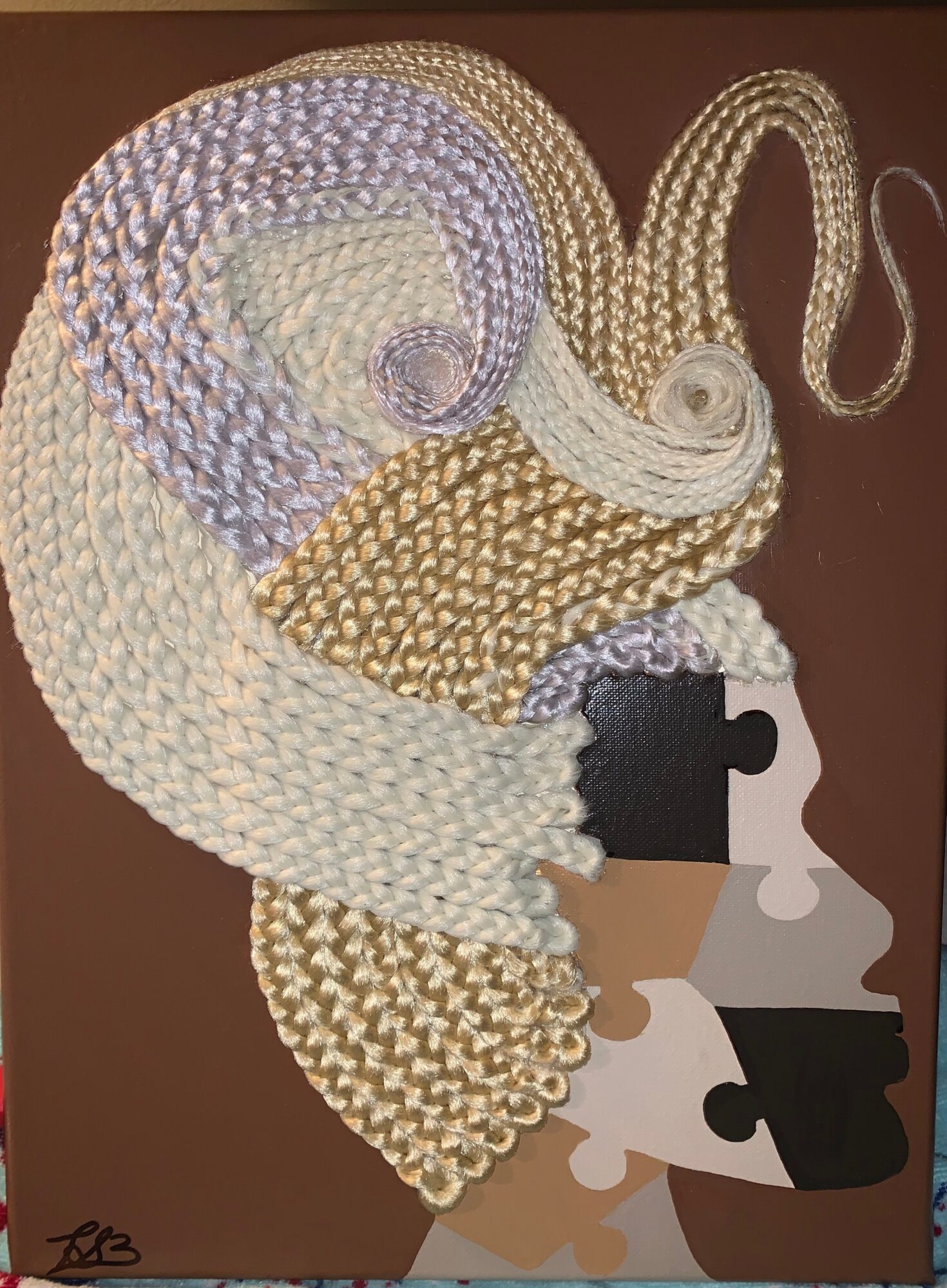 Artwork features a large, textured, spiral shape with various colors and patterns, and stylized faces at the bottom.