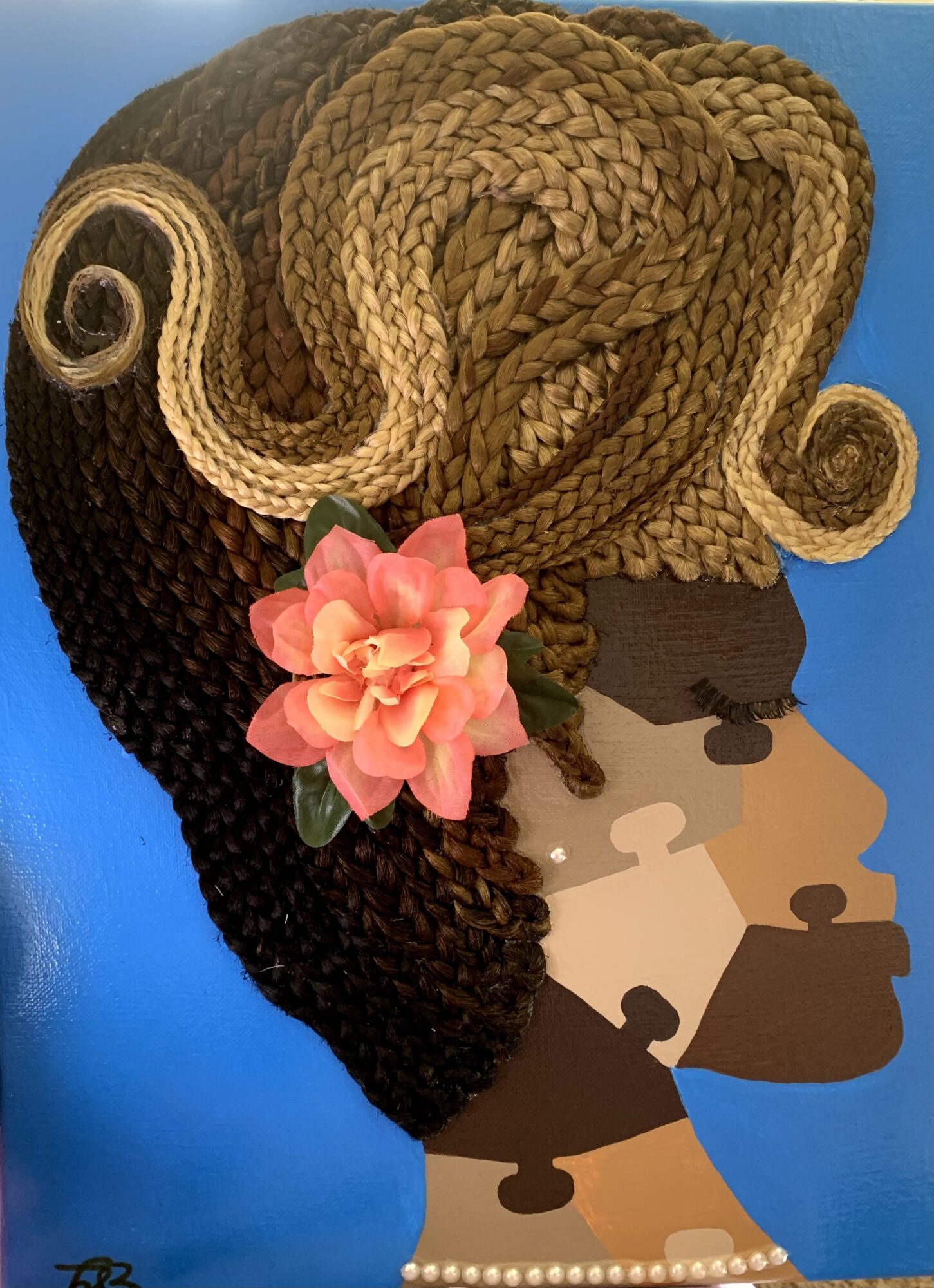 Portrait of a woman with styled hair, a pink flower in her hair, and a blue background.