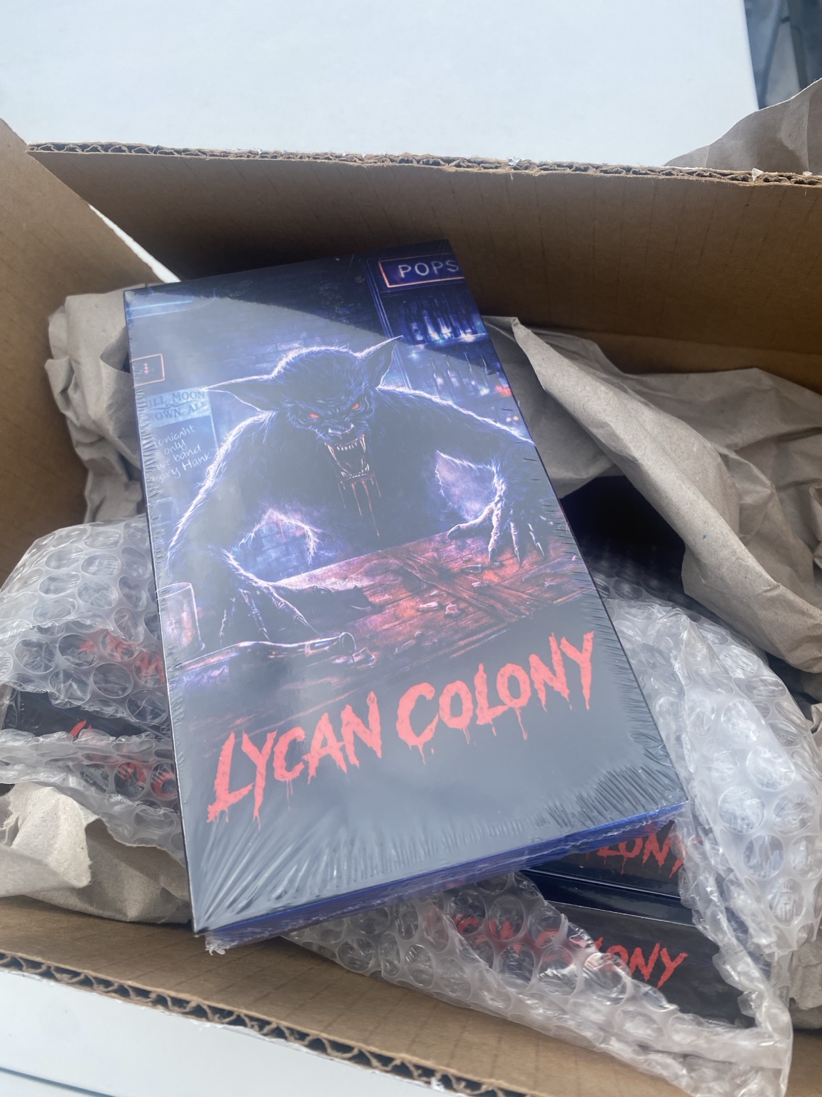 A boxed game titled 'Lycan Colony' features a creature with glowing eyes and hands, with a dark background and red text.