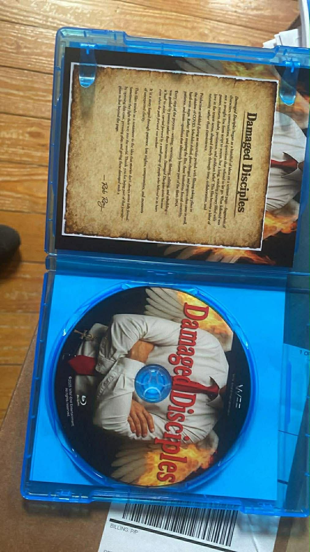 Open blue case with DVD and paper insert, DVD titled 'Dragon Ball Z' with a person in white shirt holding a sword.