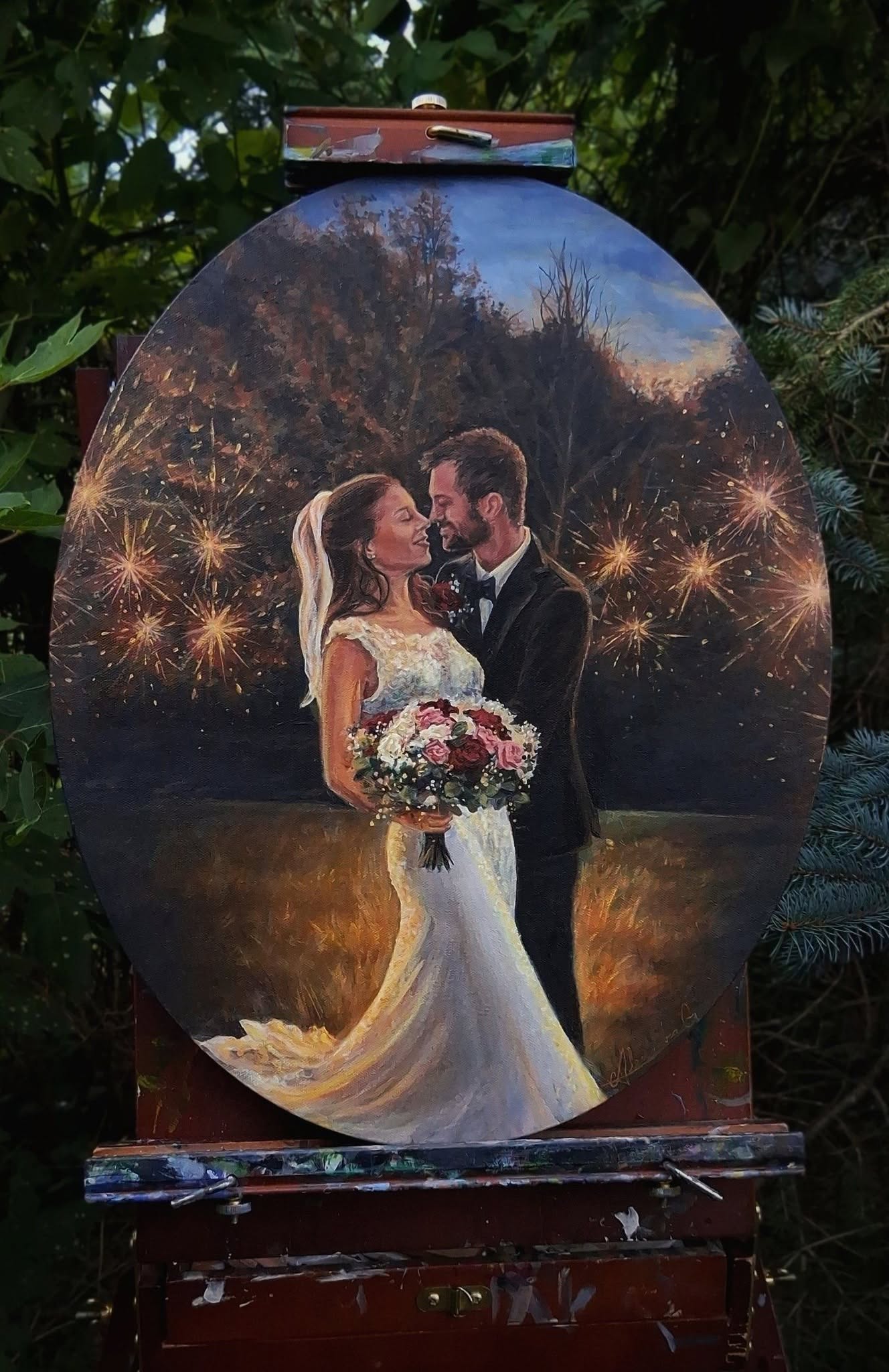 Painting of a bride and groom embracing outdoors at sunset, with fireworks in the background, holding a bouquet of flowers.