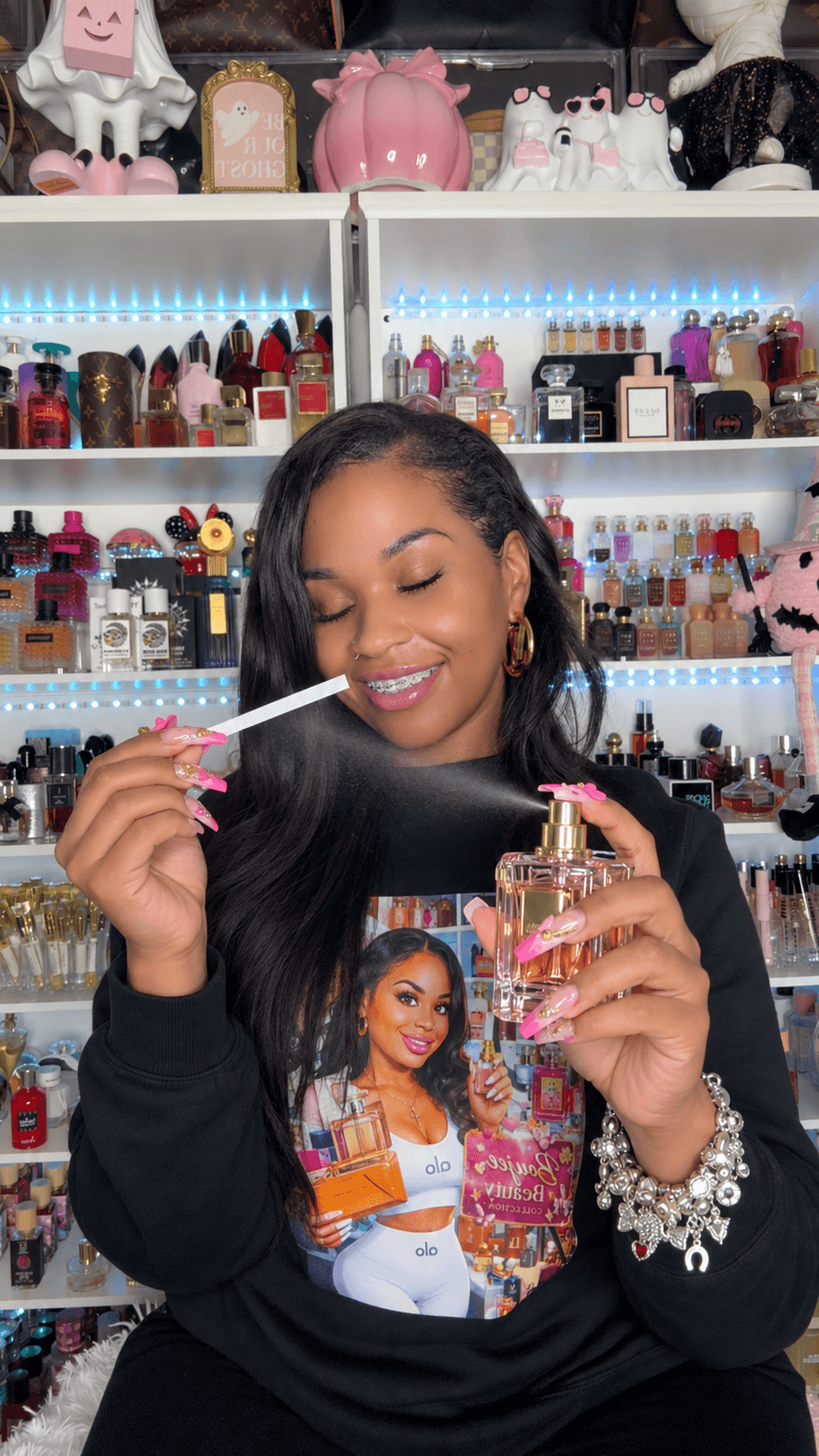 Young woman with long dark hair smiling, holding a vape pen and a pink bottle, in a store with shelves of beauty products.