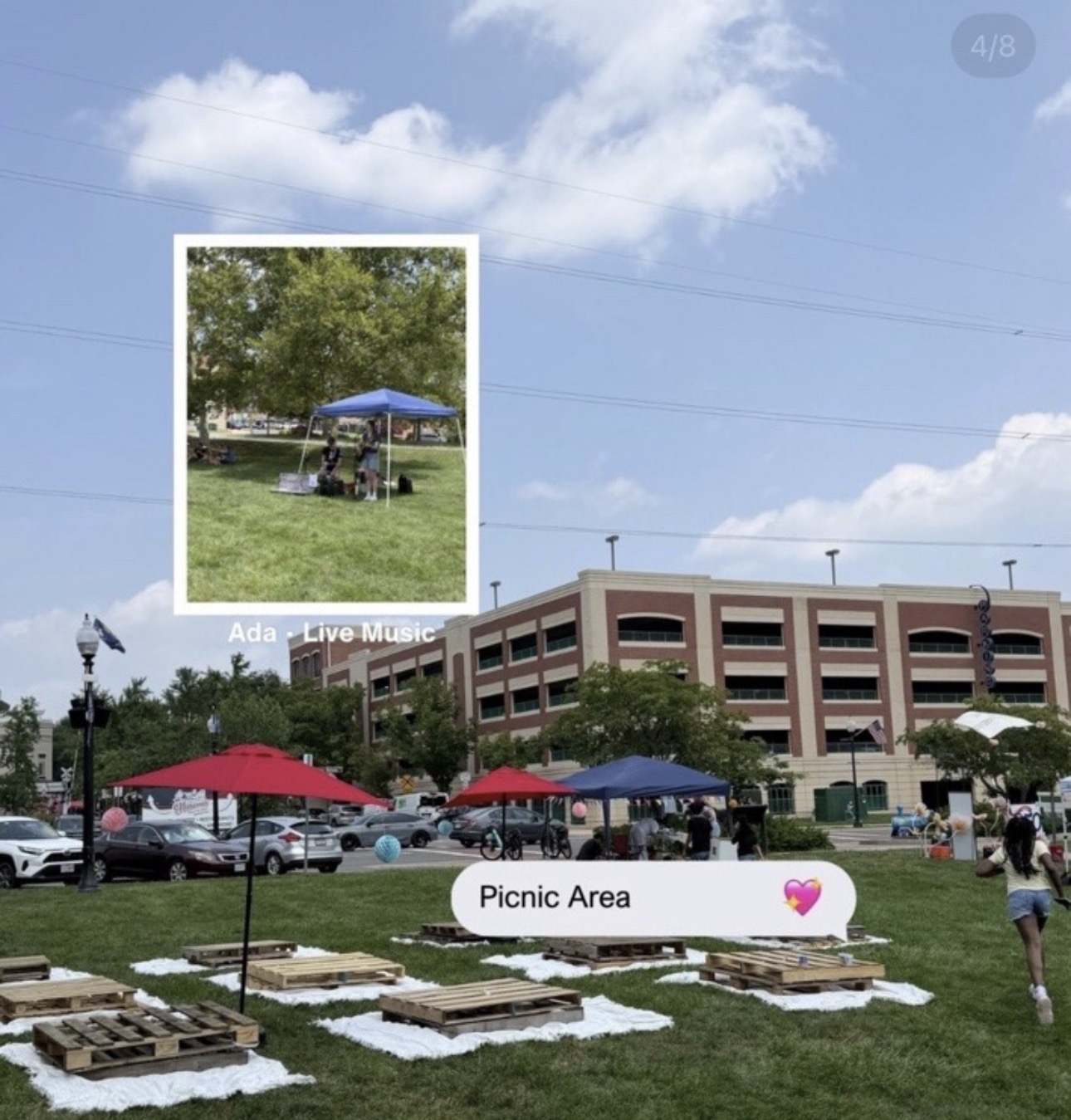 Picnic area with tables and umbrellas, people walking, building in background, blue sky with clouds, small inset photo of a park scene
