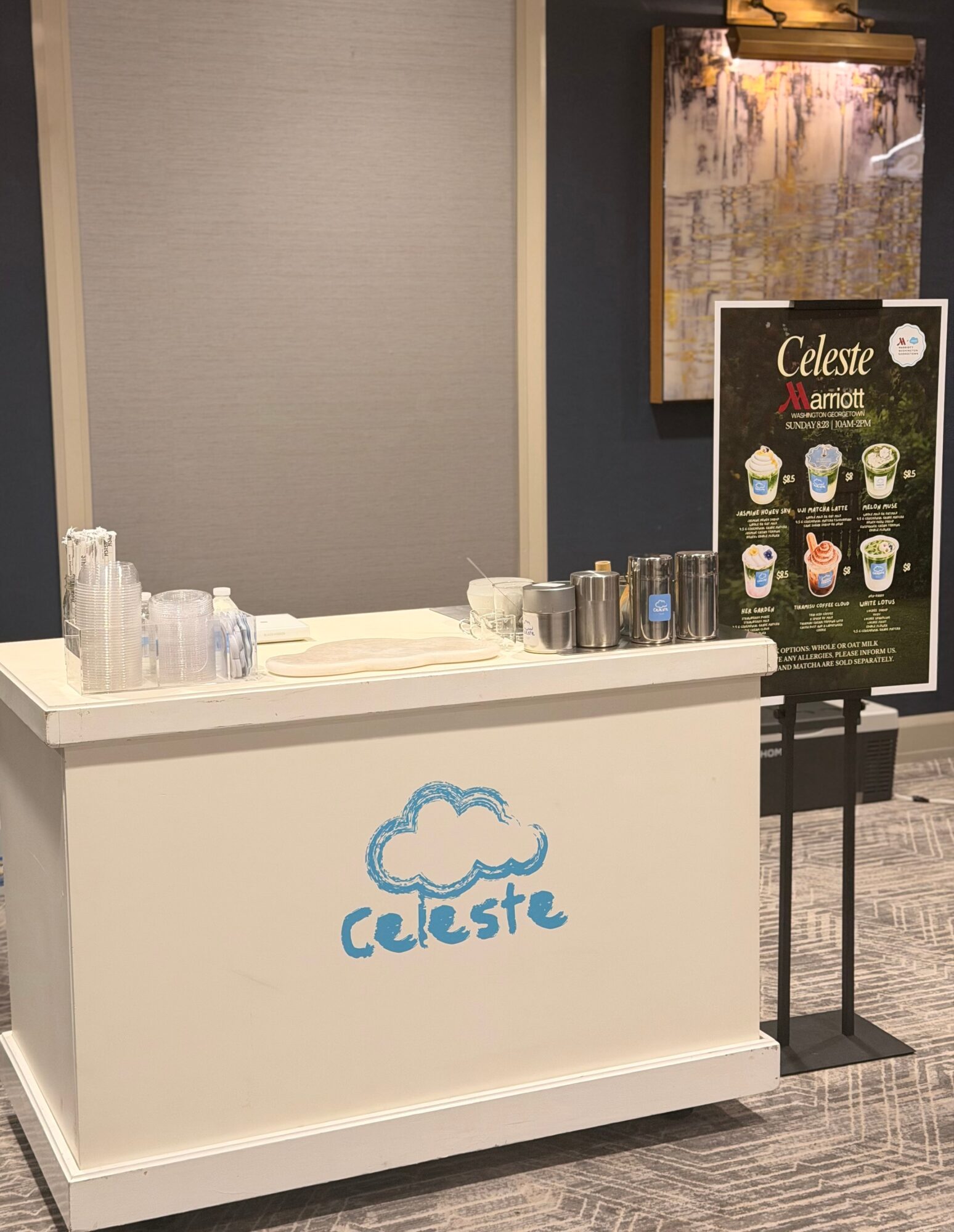 Coffee stand with a signboard displaying various coffee options, cups, and a logo with a cloud and the word 'celeste'.