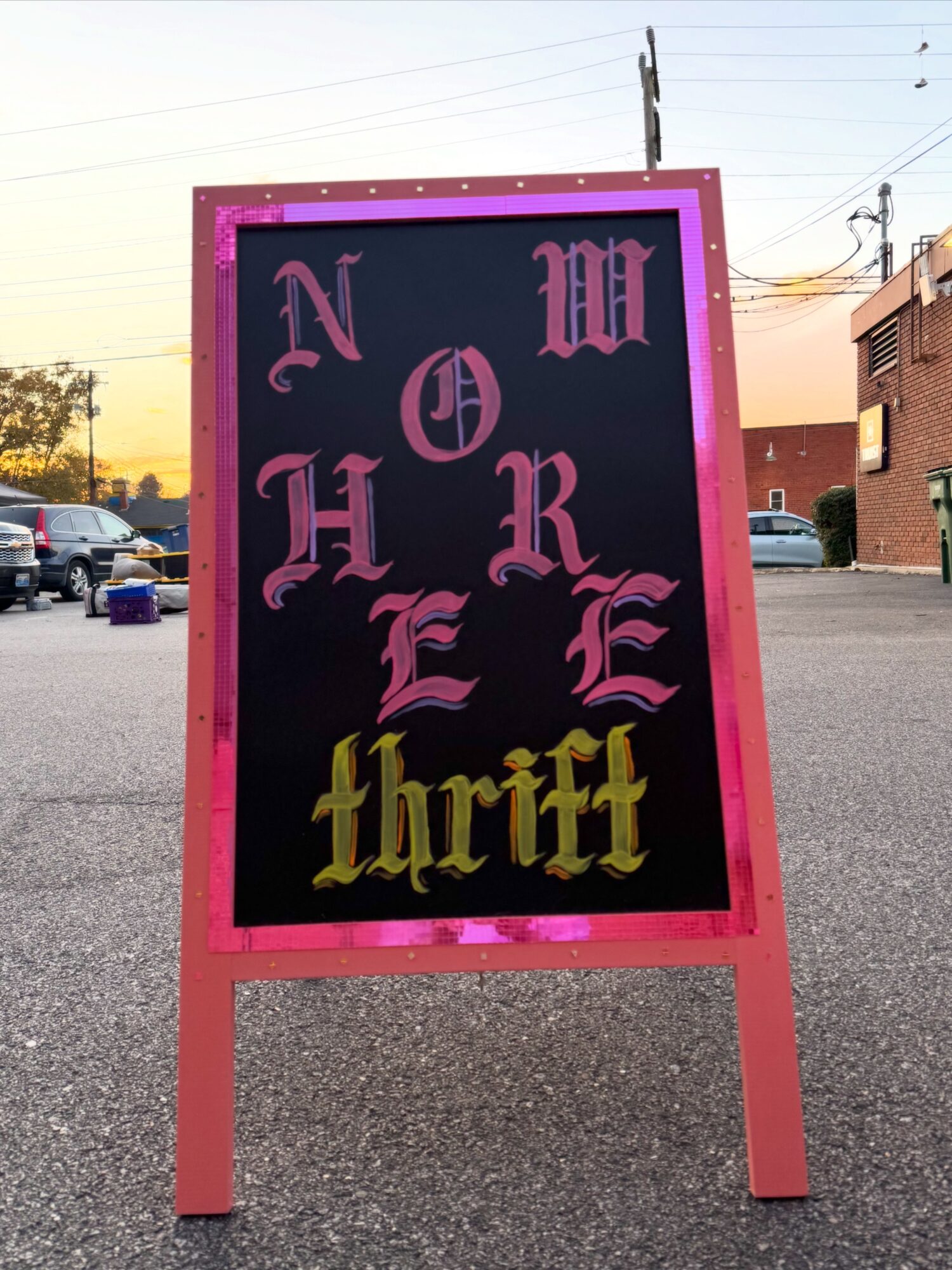A blackboard sign with pink border displays the words