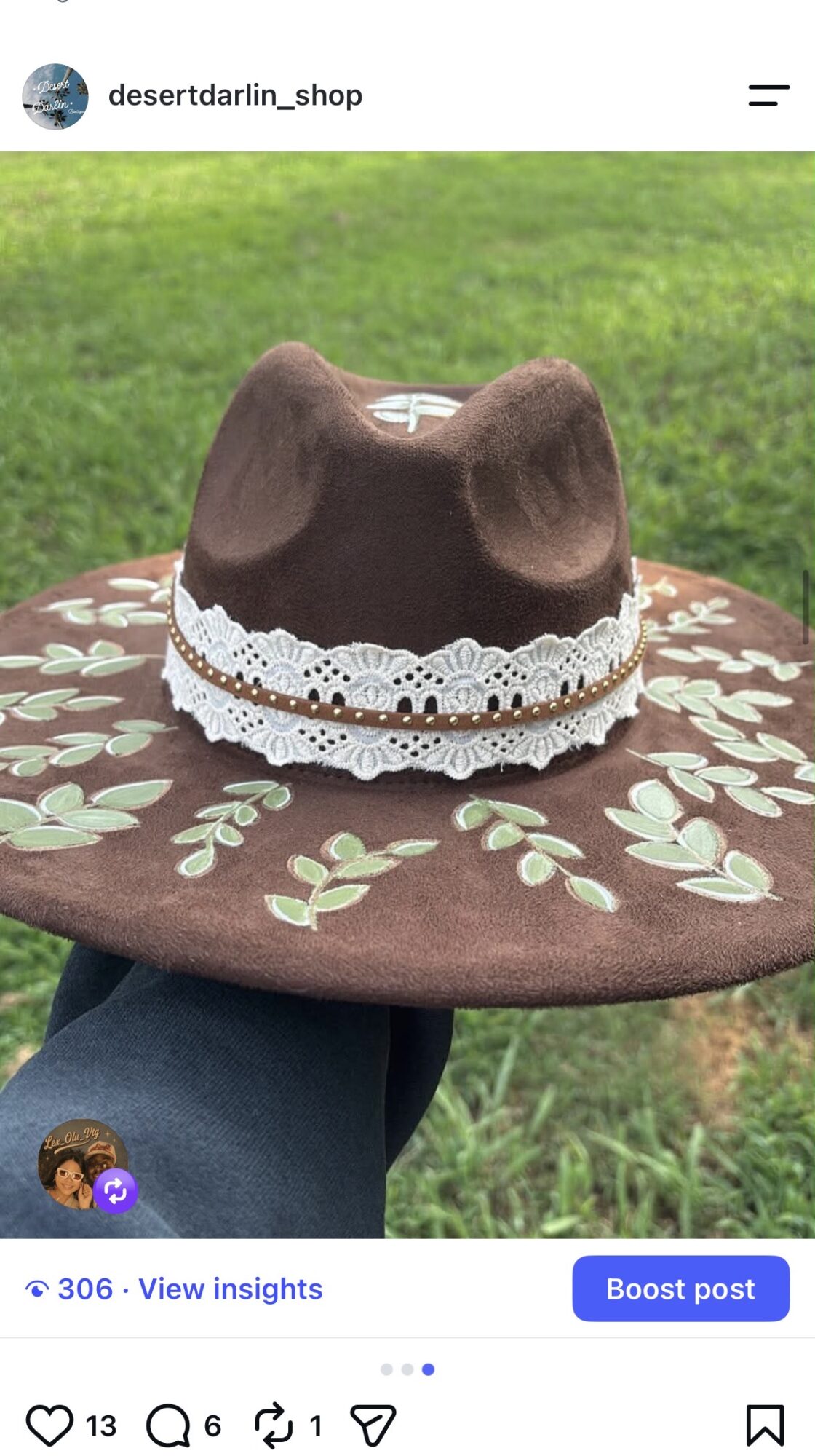 A brown wide-brimmed hat with a folded crown and white lace band rests on a patterned surface outdoors.
