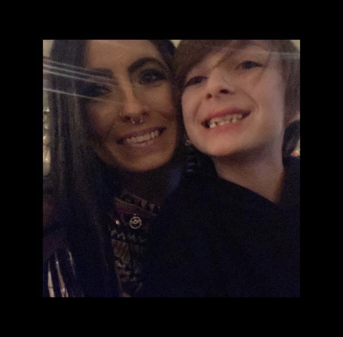 A person and a child smiling together in a close-up selfie.