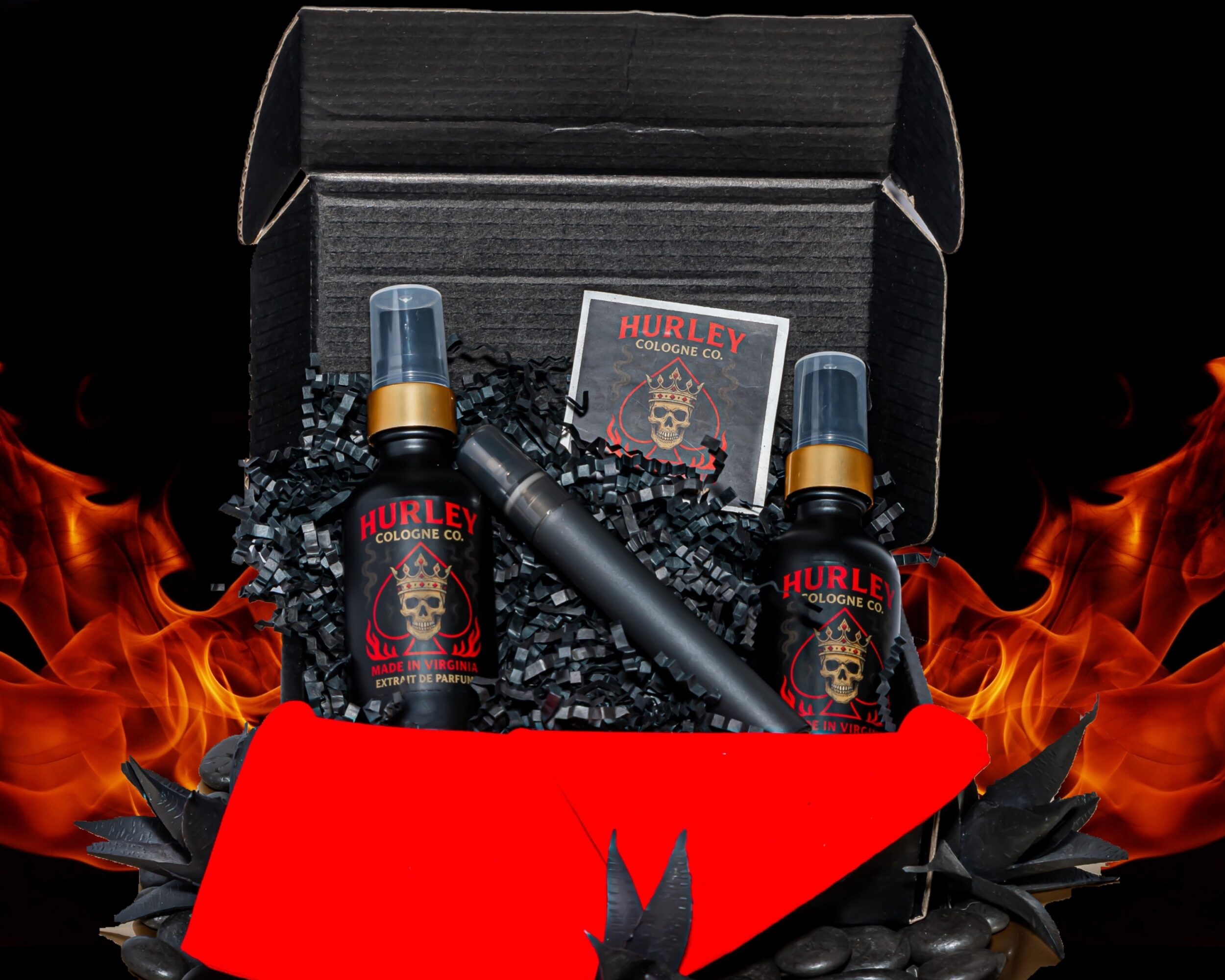 Open black box with two spray bottles, a small device, and a card, surrounded by flames and black decorative elements.