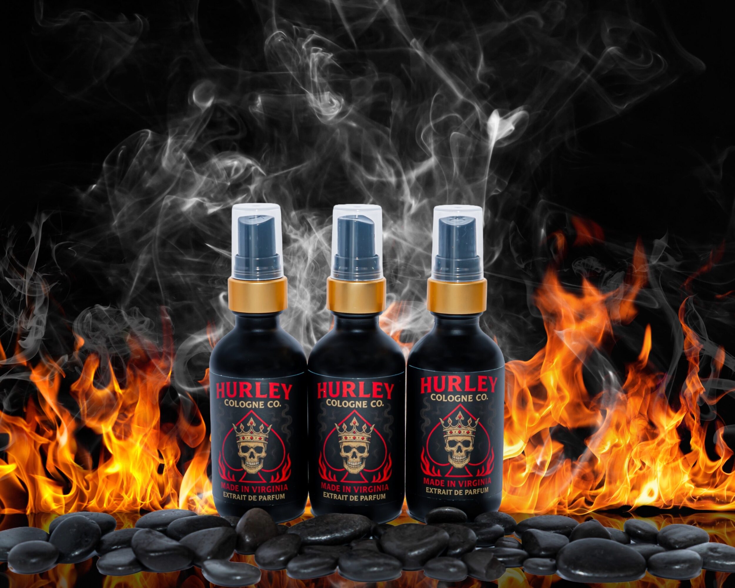 Three spray bottles labeled Hurley Cologne Co are placed on black stones with flames and smoke in the background.