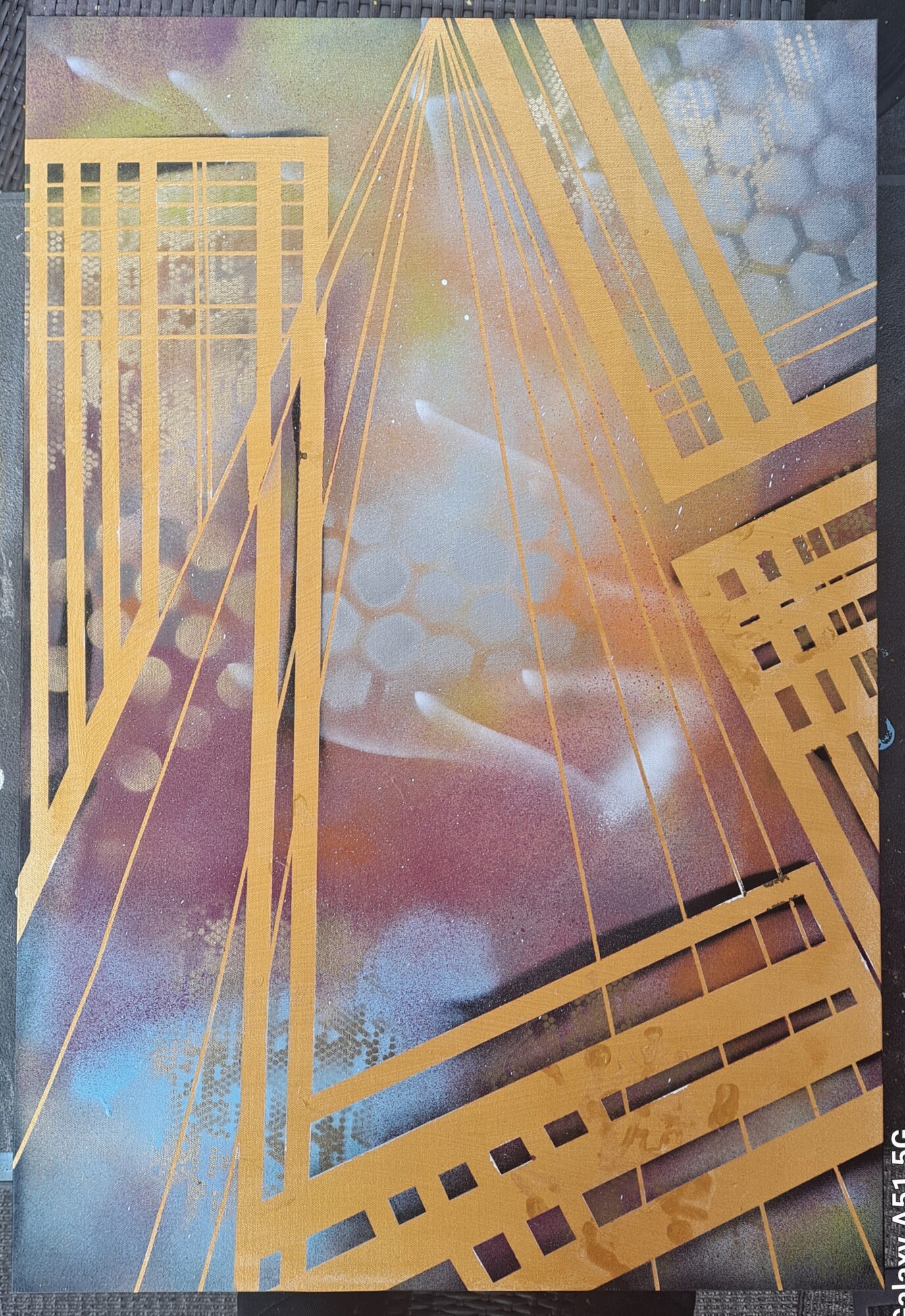 Abstract cityscape with tall buildings, golden lines, and a colorful sky background.