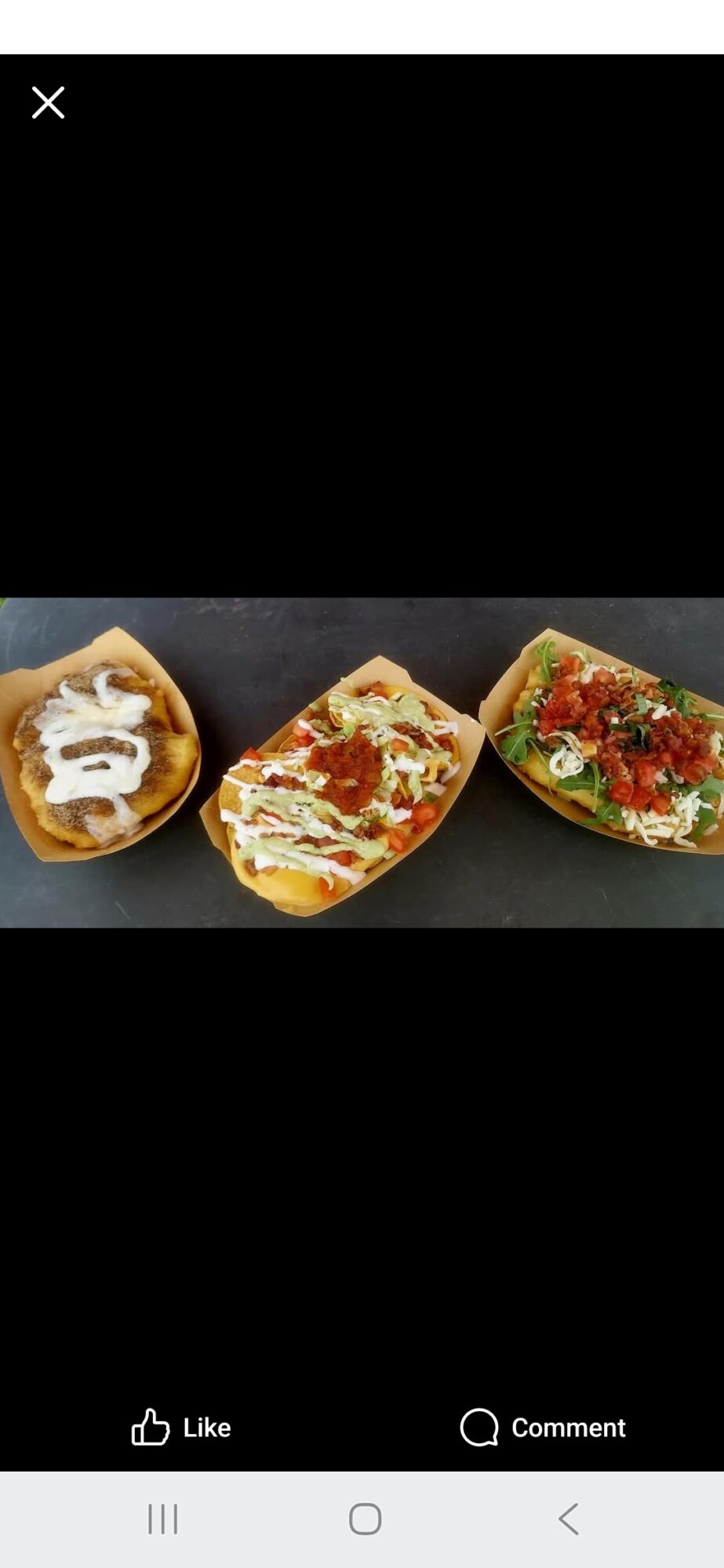 Three tacos with various fillings on a black surface, each in a different type of shell.