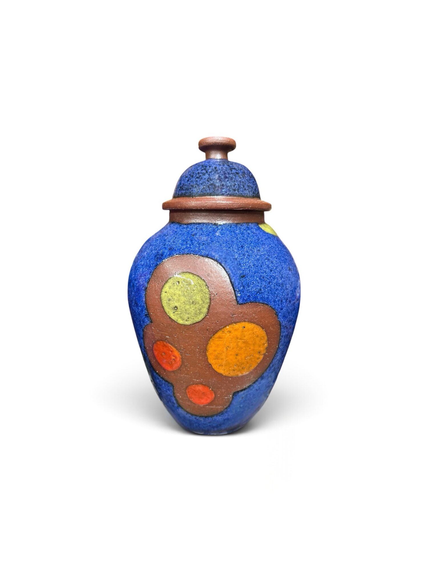 Colorful ceramic vase with a lid, decorated with circular patterns in yellow, orange, and red on a blue background.