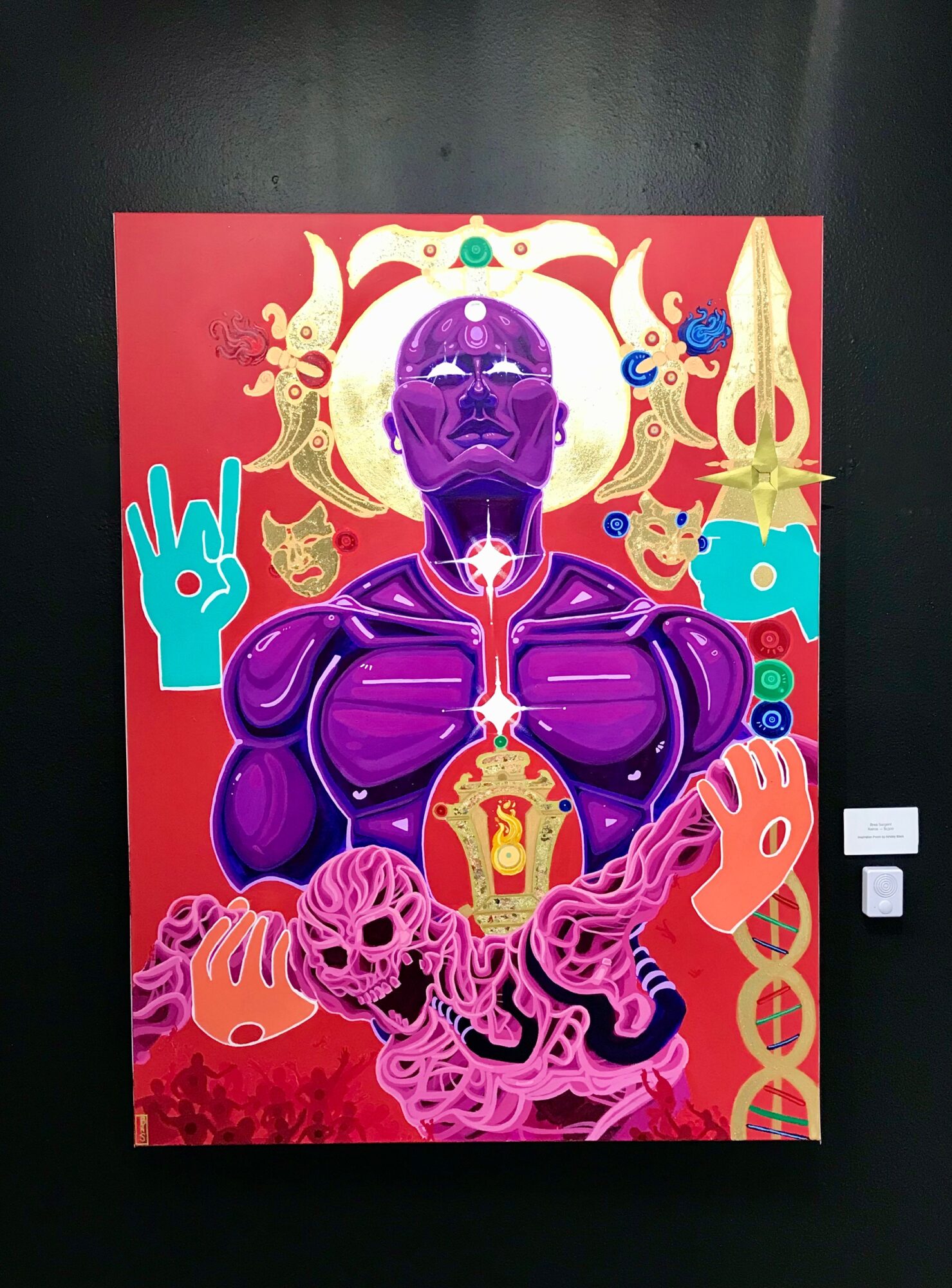 Vivid artwork of a purple humanoid figure with glowing chest and hands, surrounded by ornate golden and blue decorative elements, on a red background.