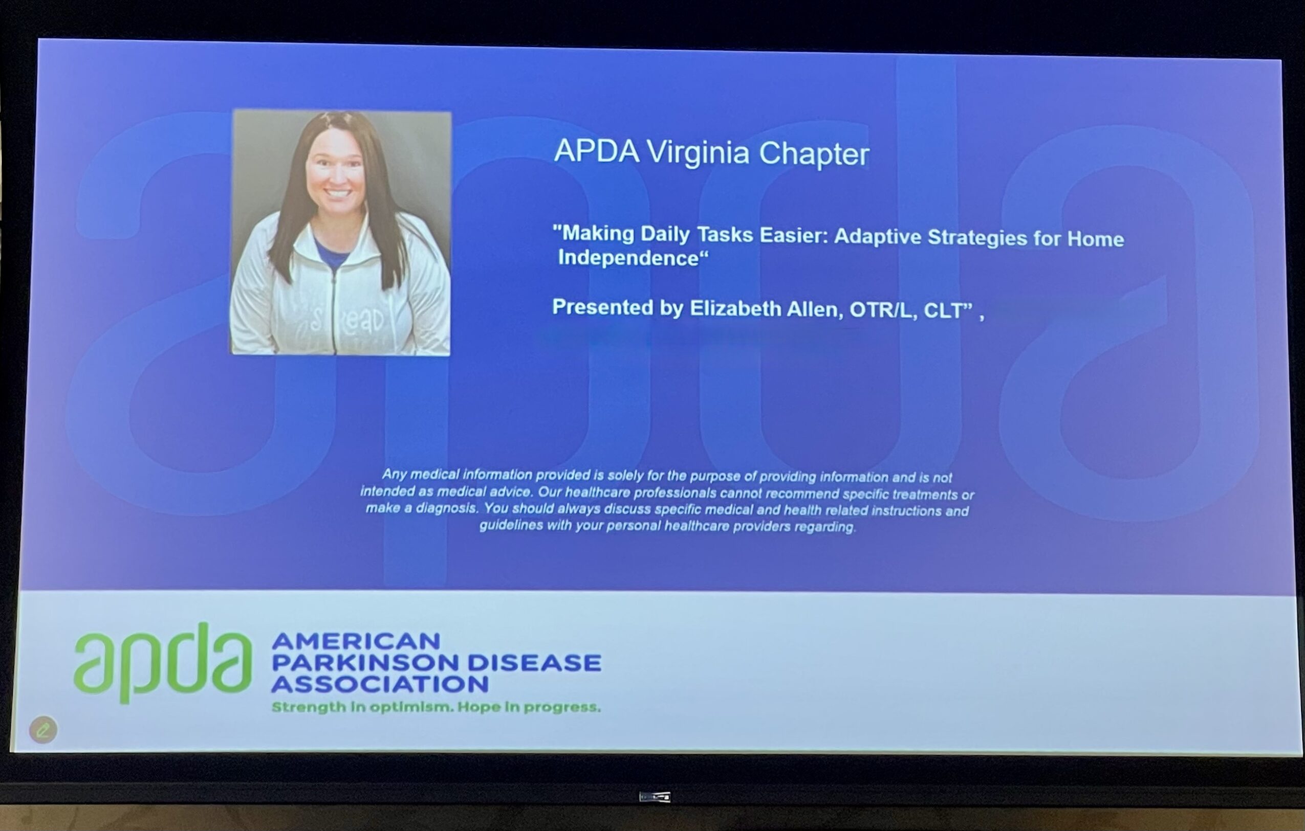Presentation slide with a woman smiling, blue background, and text about APDA Virginia Chapter and Parkinson's disease, 20 words.