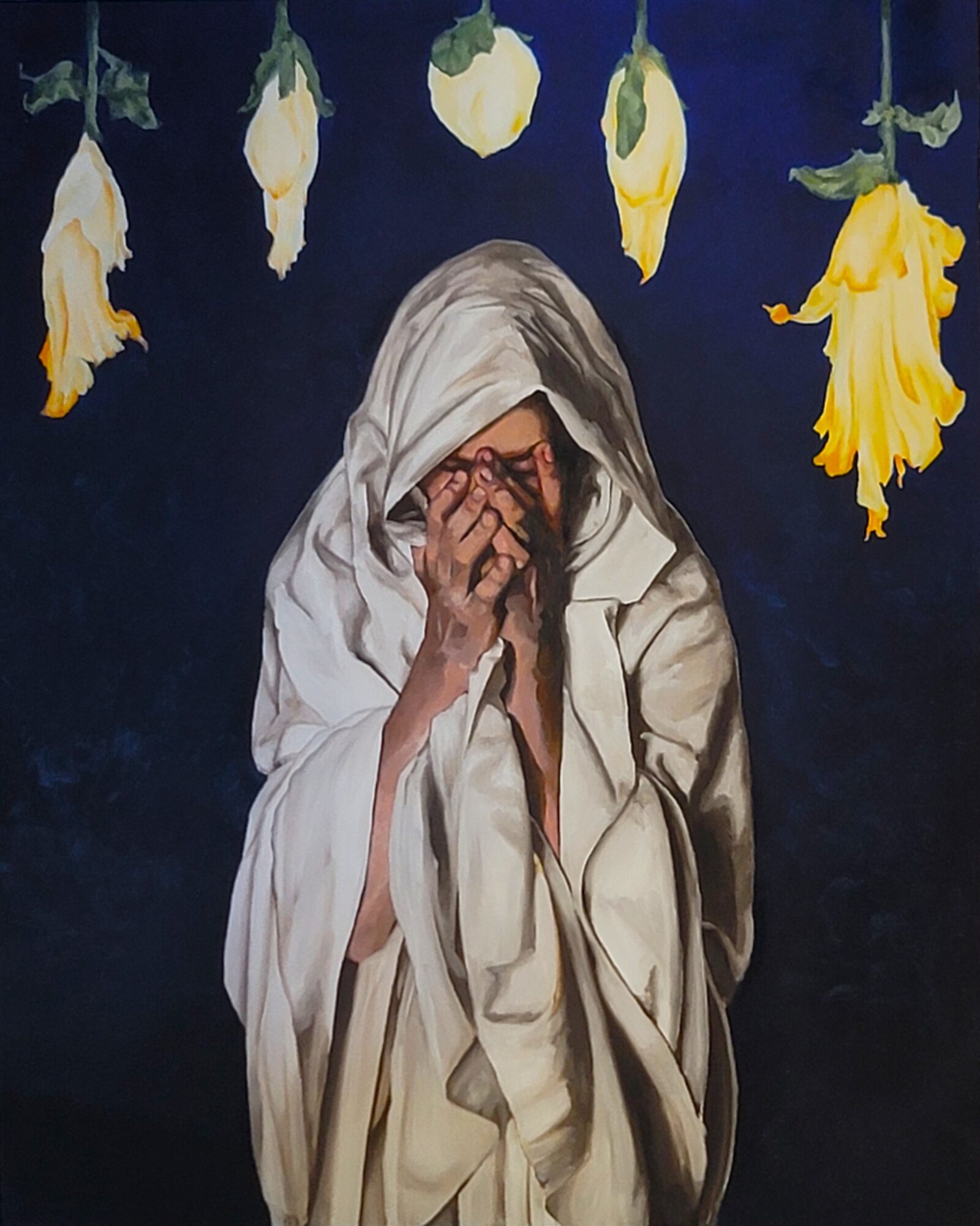 Person with a white cloth covering their head, covering face with hands, surrounded by hanging yellow and white flowers, dark background.