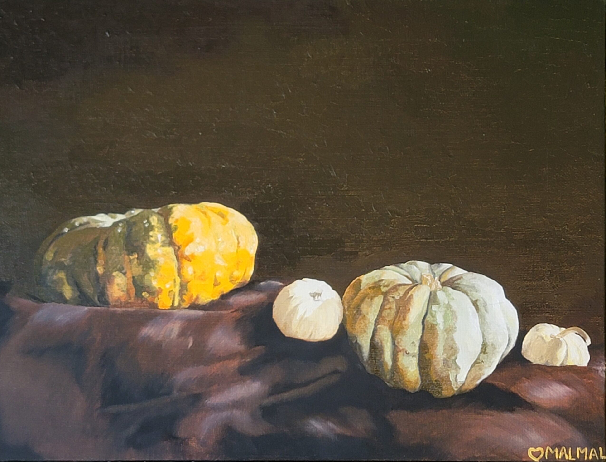 Four pumpkins of different sizes and colors on a dark surface, with a dark background.