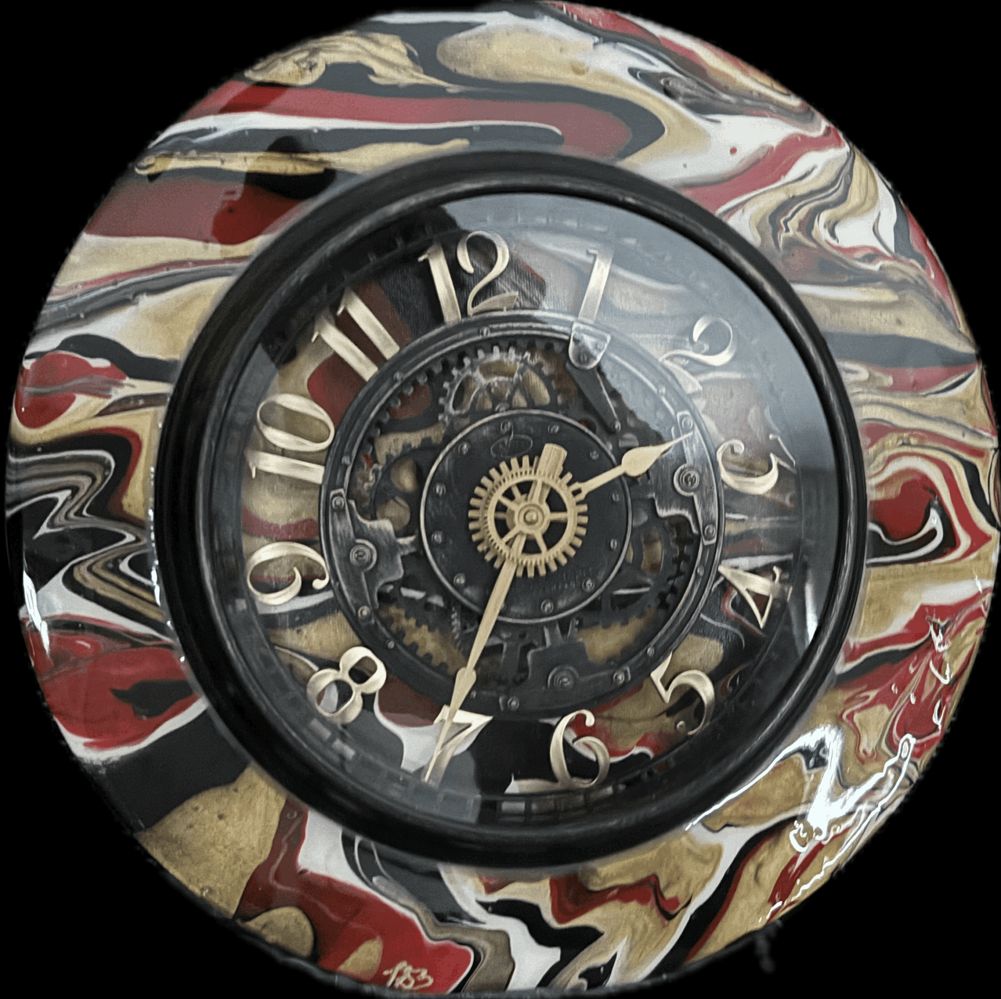 Round clock with a black frame, marbled red, black, white, and gold background, and visible gears inside.