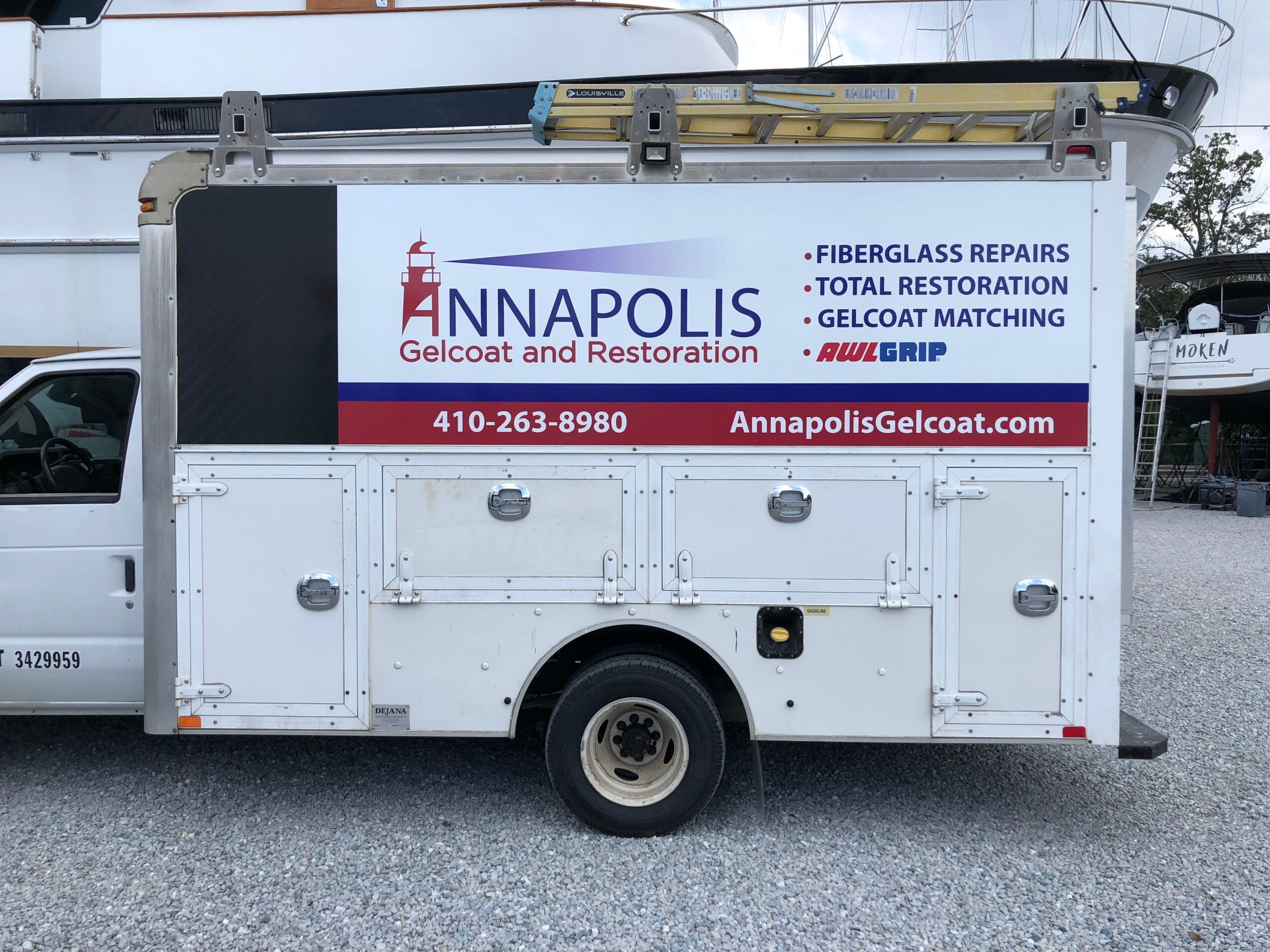 White service truck with an advertisement for Annapolis Gelcoat, displaying services and contact information.